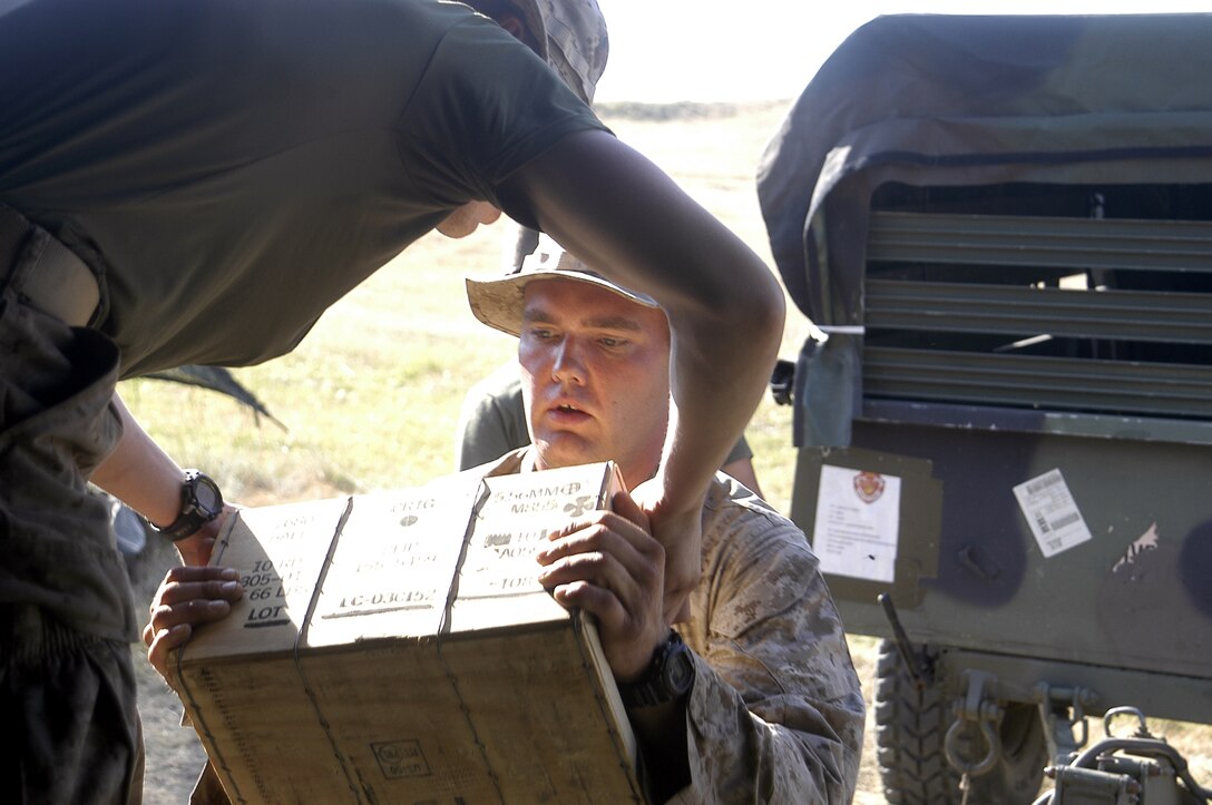 Pvt. Jason W. Hobson loads hands ammunition to Pfc. Brandon Schmitt for transportation out to the live fire range here July 17. The Marines from 3/25 are here to train the Georgian Army in infantry skills in support of Immediate Response 2008.