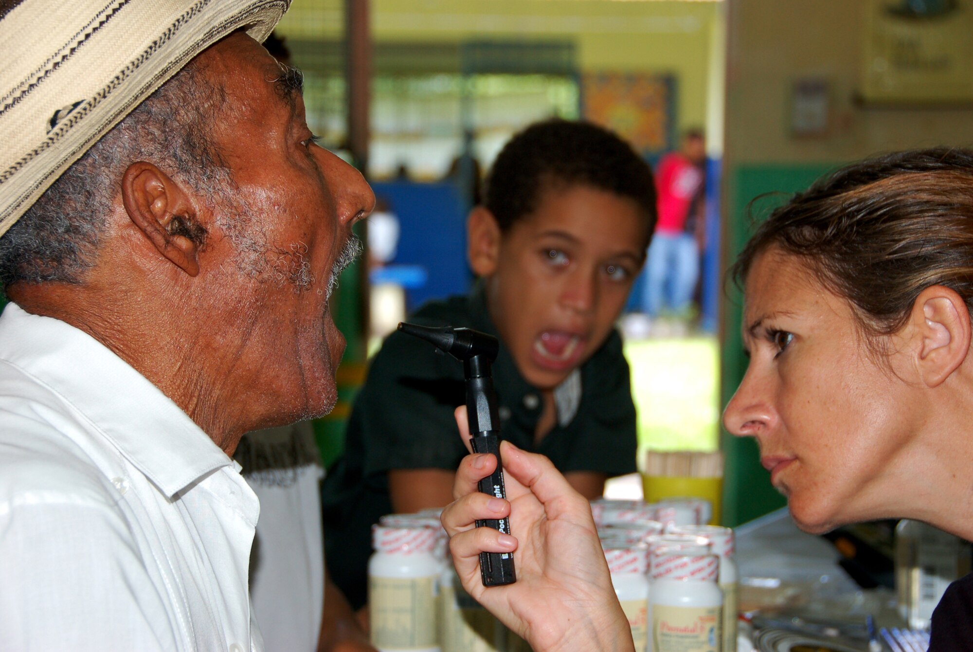 Maj. Mikelle A. Maddox, a family practice doctor here deployed to Medical Readiness Training Exercise (MEDRETE) Panama from the 42nd Medical Group at Maxwell Air Force Base, Ala., checks a patient?s oral health at a school in Santa Maria, Panama 18 July. The MEDRETE is a two-week long U.S. Southern Command sponsored exercise designed to hone the skills of medical personnel while providing free health care in remote locations through partnership with host nation doctors. Approximately 3,100 patients have been seen by the medical staff from 14-18 July. (Photo by Capt. Ben Sakrisson, Air University Public Affairs)