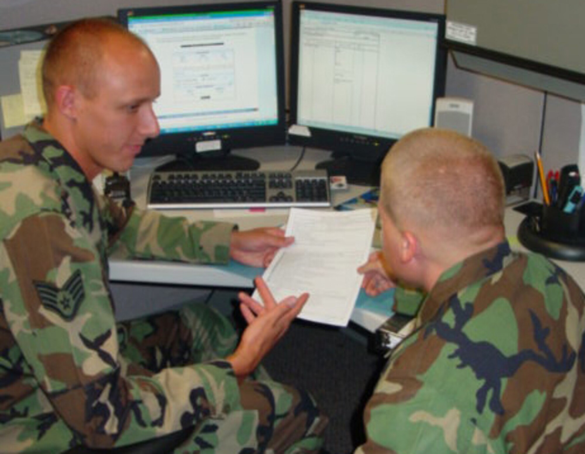 BUCKLEY AIR FORCE BASE, Colo. -- Staff Sgt. Michael Mechaley, 460th Comptroller Squadron, goes over paperwork with a finance customer at Bldg. 606 here. The Omaha, Neb., native is the Warrior of the Week for July 18 - 24. (Courtesy photo)
