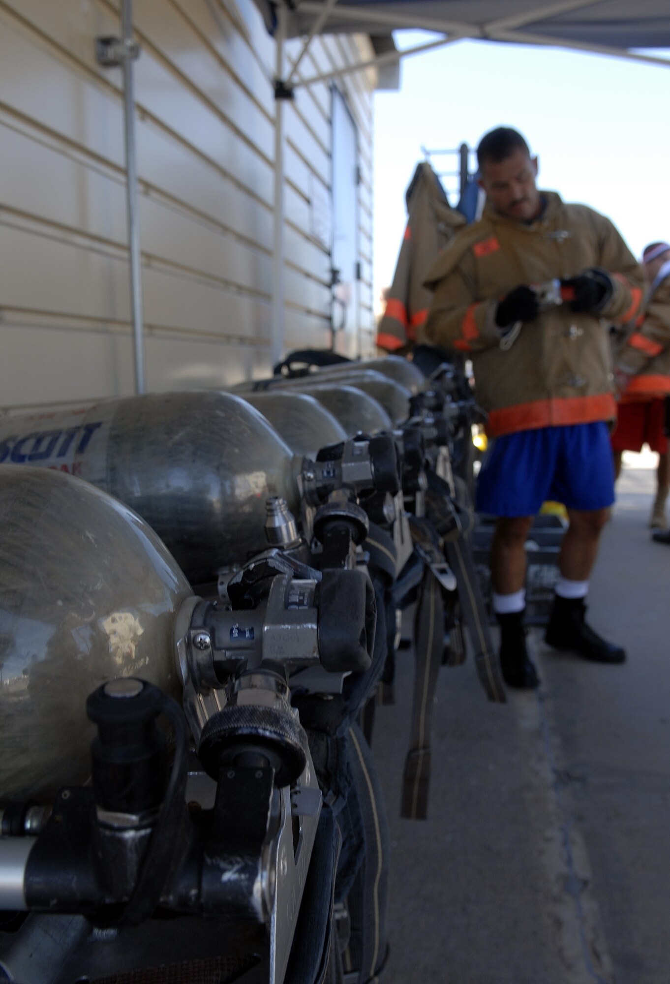 Each participant in the Rookie Firefighter Combat Challenge July 12 wore oxygen packs, which weighed approximately 30 pounds. (U.S. Air FOrce photo by Senior Airman Kamaile Chan)