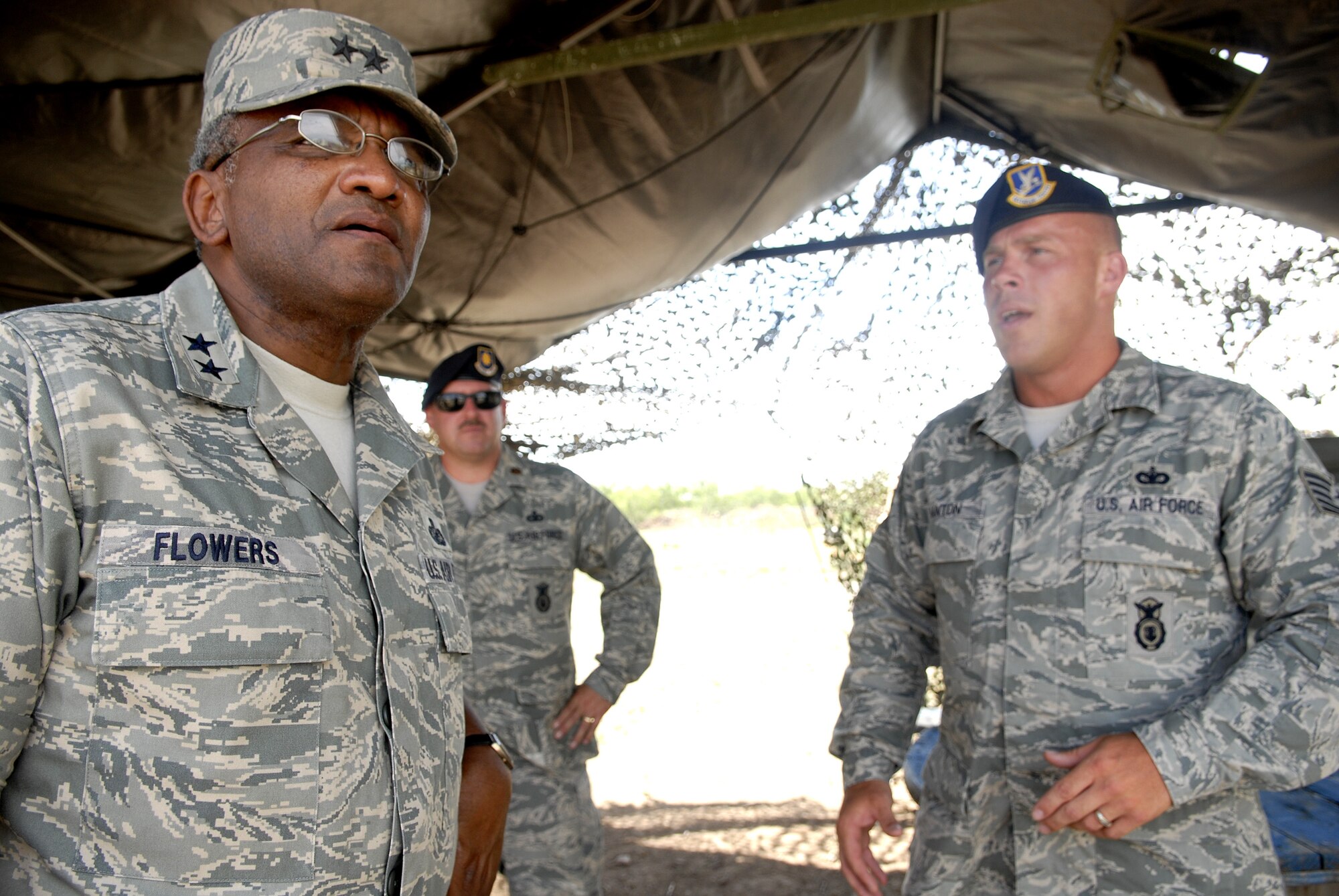 Major General Alfred Flowers, 2nd Air Force commander, receives a briefing from Tech. Sgt. David Banton, 17th Security Forces Squadron, during his visit to the new Global War on Terrorism training grounds July 15 on Goodfellow Air Force Base. General Flowers visited Goodfellow earlier this week, touring various squadrons around base. (U.S. Air Force photo by Senior Airman Kamaile Chan)