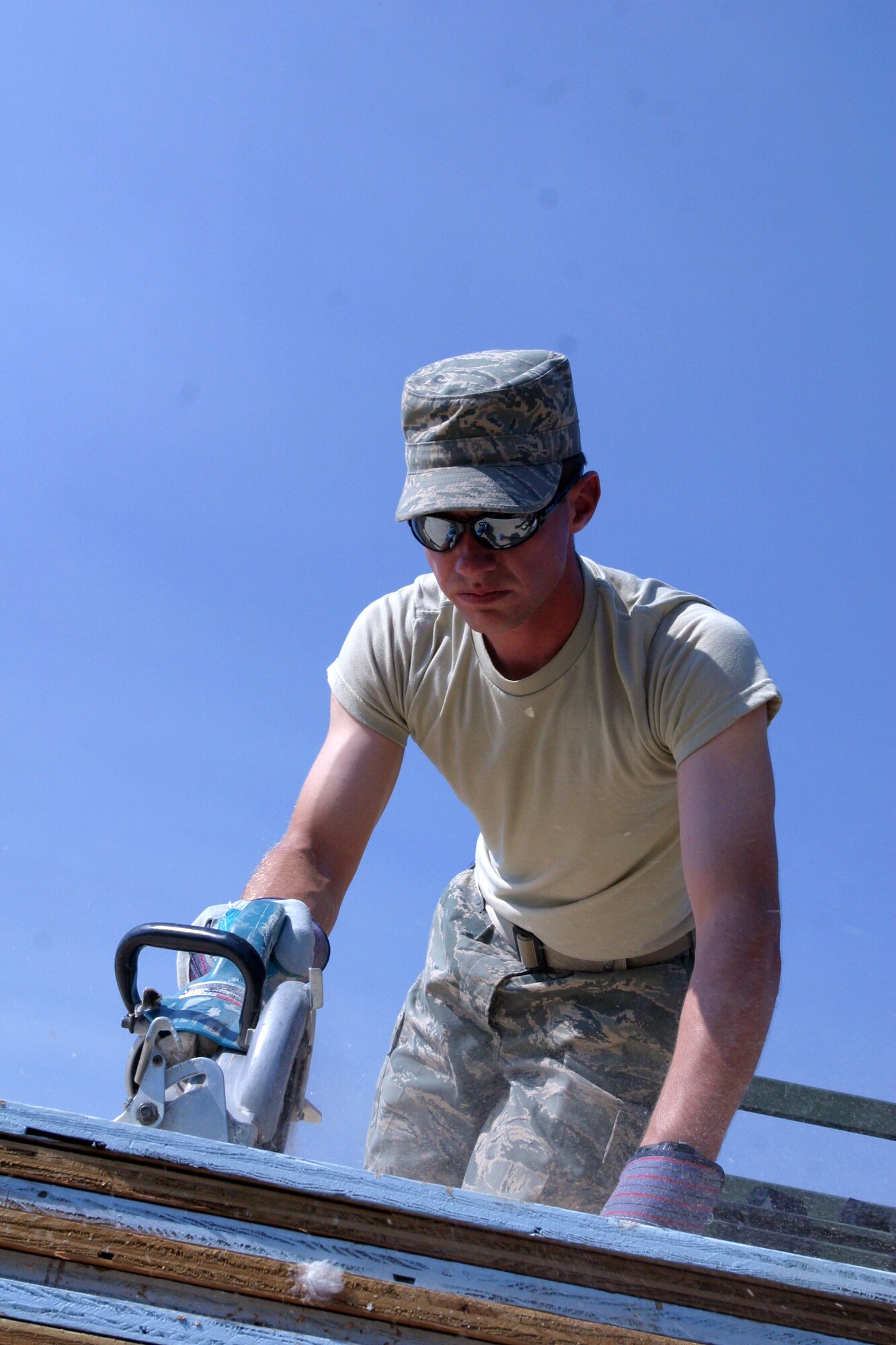 Senior Airman Randy Hyer, from the 419th Civil Engineer Squadron, cuts a board while building a shelter during a training exercise during the July Unit Training Assembly. The exercise gave CE members a chance to practice crucial skills and receive important training. 