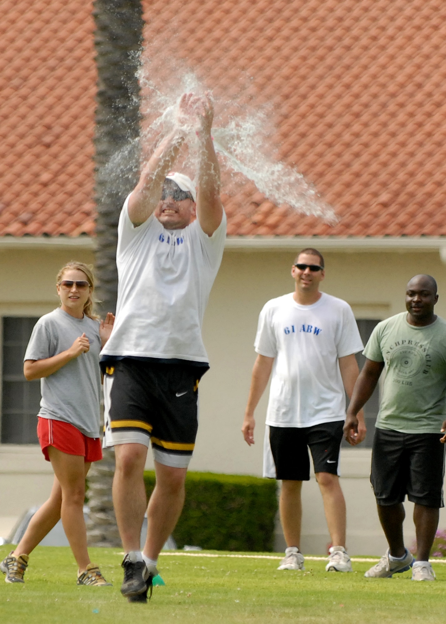 Lt. Jonathan Walsh, 61st Air Base Wing, blocks an incoming water balloon from hitting the target during the balloon catapult competition, July 10. The Space Superiority Systems Wing took this year’s overall Sports Day crown. (Photo by Stephen Schester)