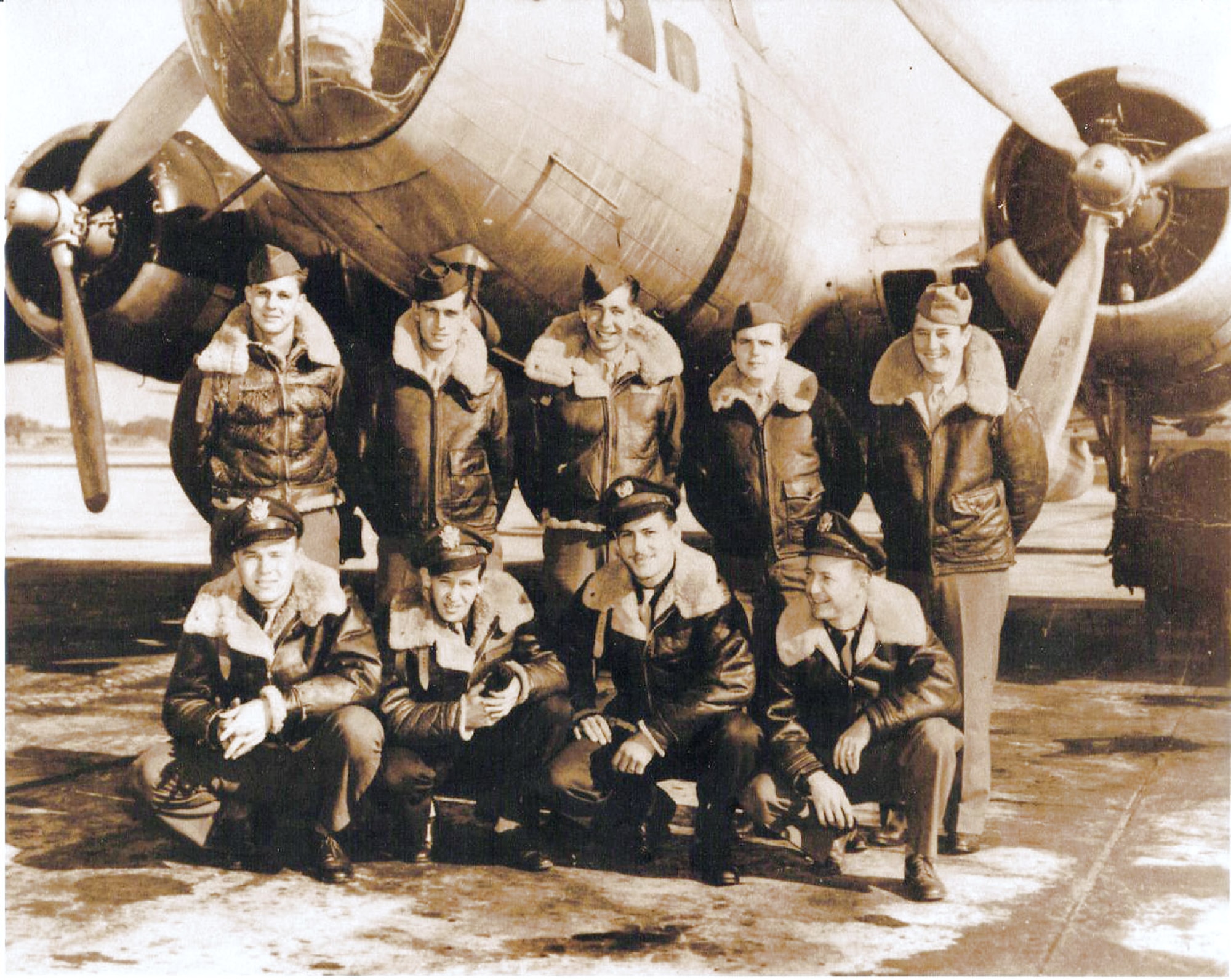 A World War II flight crew stands in front of the "Heaven's Above." Howard Gibbs is center in the back row. (Courtesy photo) 
