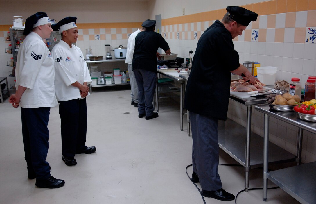 LANGLEY AIR FORCE BASE, Va. -- Senior Airman Ashley Martinez and Senior Airman Kelmer Rapisora, 1st Force Support Squadron food service journeymen, judge an inter-service cook-off at the Culinary Institute of Virginia in Norfolk July 17.  The cook-off was between two navy teams from the Norfolk Naval Air Station. (U.S. Air Force photo/Tech. Sgt. Levi Collins) 