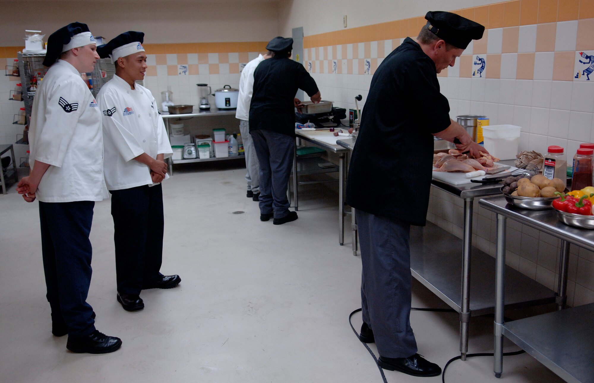 LANGLEY AIR FORCE BASE, Va. -- Senior Airman Ashley Martinez and Senior Airman Kelmer Rapisora, 1st Force Support Squadron food service journeymen, judge an inter-service cook-off at the Culinary Institute of Virginia in Norfolk July 17.  The cook-off was between two navy teams from the Norfolk Naval Air Station. (U.S. Air Force photo/Tech. Sgt. Levi Collins) 