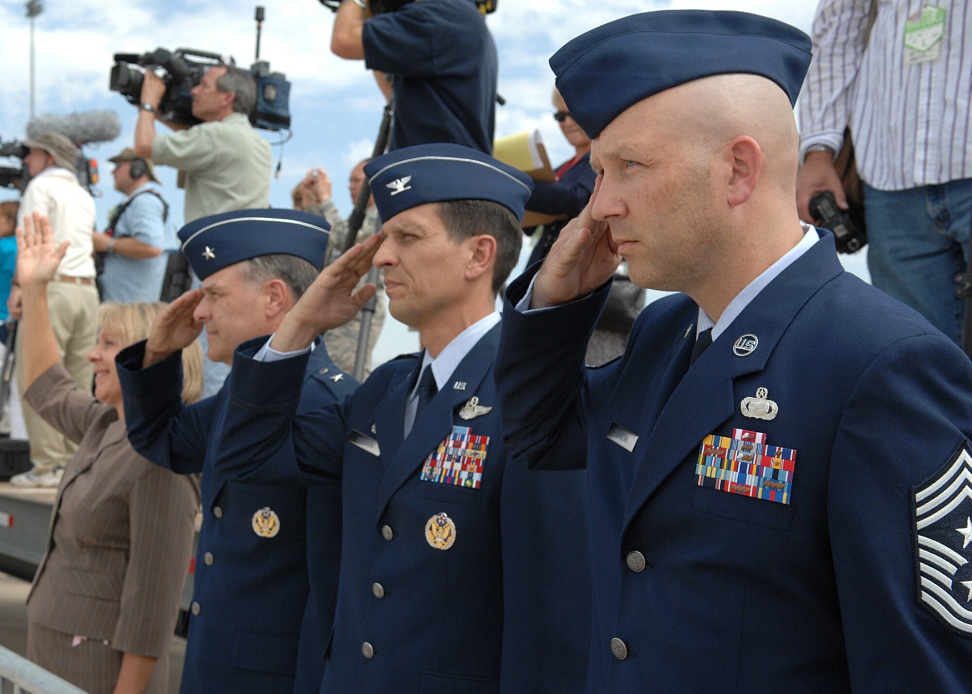 Chief Master Sgt. Thomas Schwenk, 355th Fighter Wing command chief, Col. Paul Johnson, 355th Fighter Wing commander and Brig. Gen. Joseph Mudd, 12th Air Force (Air Forces Southern) vice commander salute Air Force One as President George W. Bush departs Davis-Monthan Air Force Base, Ariz. July 18.  (U.S. Air Force photo by Senior Airman Alesia Goosic)  