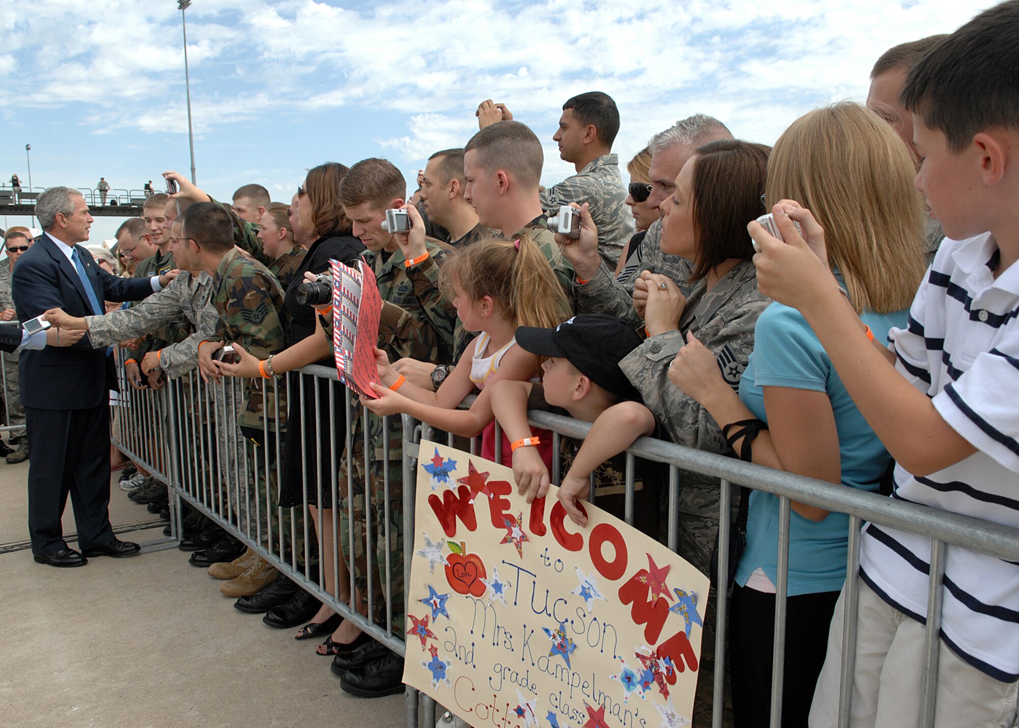 President George W. Bush greets Davis-Monthan Air Force Base Airmen and their families July 18 before departing after a short trip to Tucson, Ariz.  More than 100 members of the D-M team gathered at Base Ops to shake hands and take photos with the president.  (U.S. Air Force photo by Senior Airman Alesia Goosic)