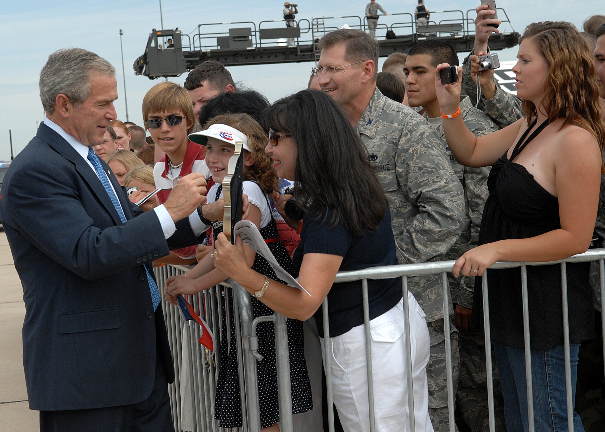 President George W. Bush greets Davis-Monthan Air Force Base Airmen and their families July 18 before departing after a short trip to Tucson, Ariz.  More than 100 members of the D-M team gathered at Base Ops to shake hands and take photos with the president.  (U.S. Air Force photo by Senior Airman Alesia Goosic)