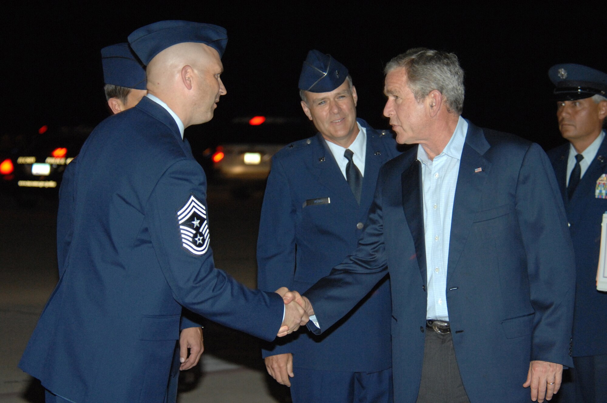 Chief Master Sgt. Thomas Schwenk, 355th Fighter Wing command chief, greets President George W. Bush as he arrives at D-M July 17. President Bush came to Tucson, AZ to attend a VIP breakfast. (U.S. Air Force photo by Airman 1st Class Noah R. Johnson)