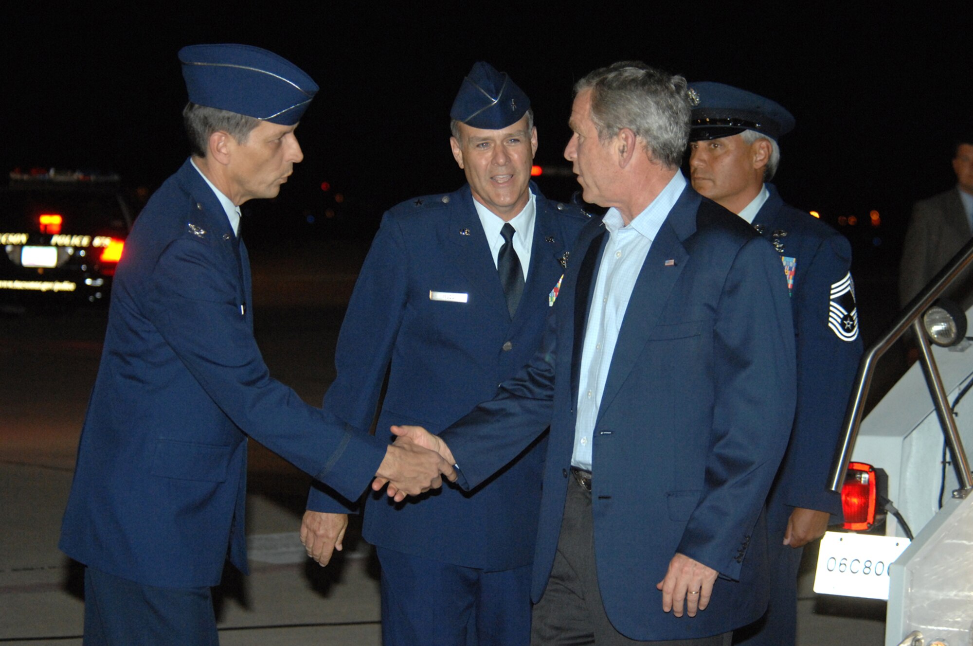 Col. Paul Johnson, 355th Fighter Wing Commander, greets President George W. Bush as he arrives at Davis-Monthan Air Force Base, Ariz., July 17. President Bush came to Tucson to attend a VIP breakfast and to award Mary Frances-Ward with the President's Volunteer Service Award for outstanding volunteer service in her community. President Bush has honored more than 650 volunteers since 2002. (U.S. Air Force photo by Airman 1st Class Noah R. Johnson)