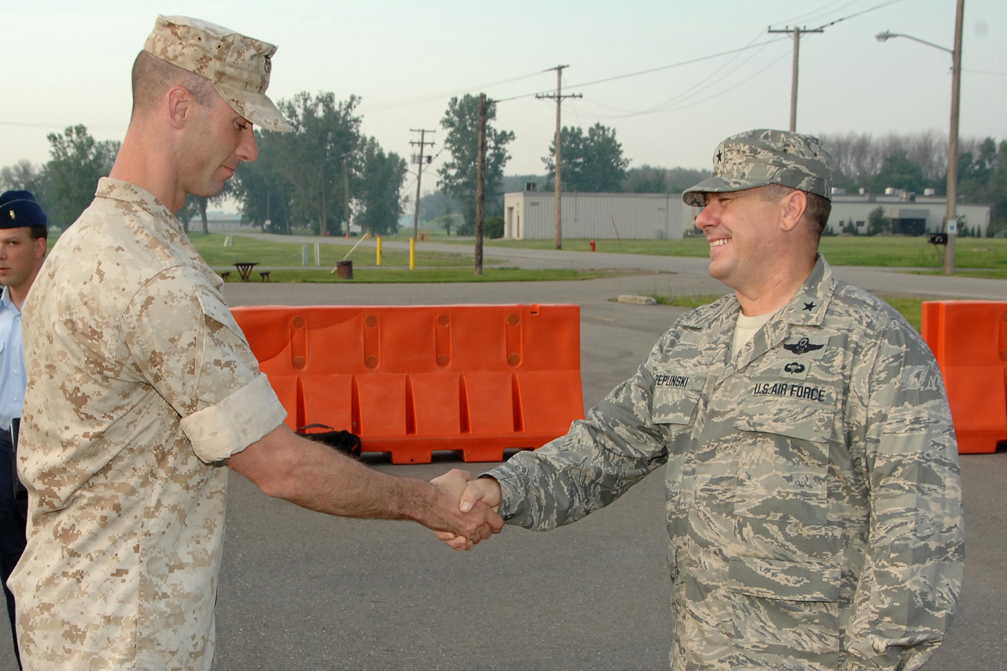 Brig. Gen. Michael L. Peplinski, 127th Wing commander (right), congratulates Marine Reservist Sergeant Shawn Wilson on the awarding of a Bronze Star on July 18, 2008, at Selfridge Air National Guard Base, Mich.  In 2006, Sergeant Wilson, formerly of the 1st Battalion, 24th Marine Regiment, based out of Selfridge, was assigned to a combat unit in aiding in the penetration of Sadam Hussein’s regime in order to enable the liberation of Iraq and combat terrorism  when he earned the award for three separate acts of heroism. 