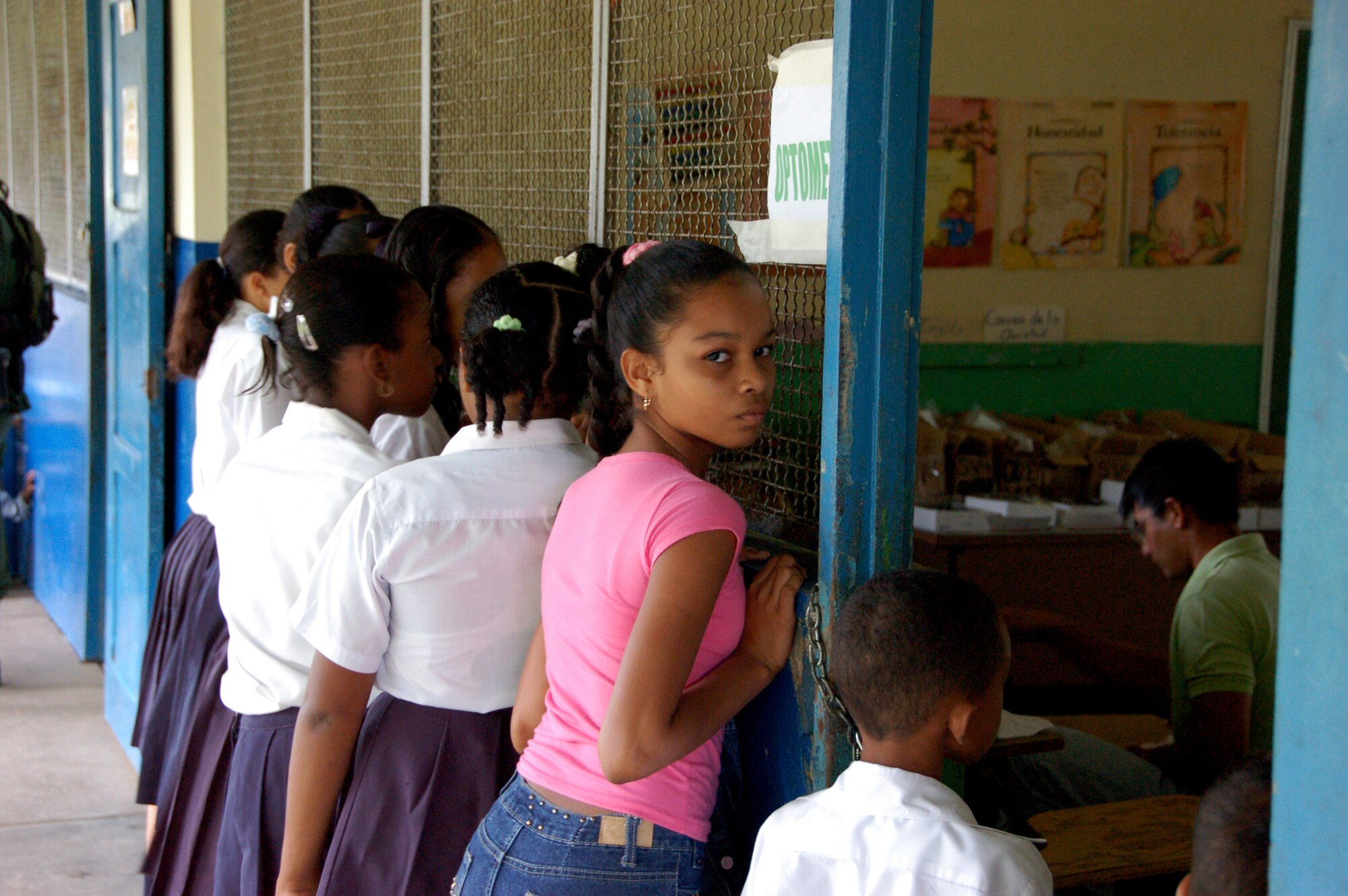 Panamanian school children peer through a window July 17 as U.S. Air Force members set up an optometrist office at a school in Santa Maria, Panama, as part of a Medical Readiness Training Exercise. The MEDRETE is a two-week long U.S. Southern Command sponsored-exercise designed to hone the skills of medical personnel while providing free health care in remote locations through partnership with host nation doctors. Approximately 2,350 patients have currently been seen by the medical staff. (U.S. Air Force photo/Capt. Ben Sakrisson) 