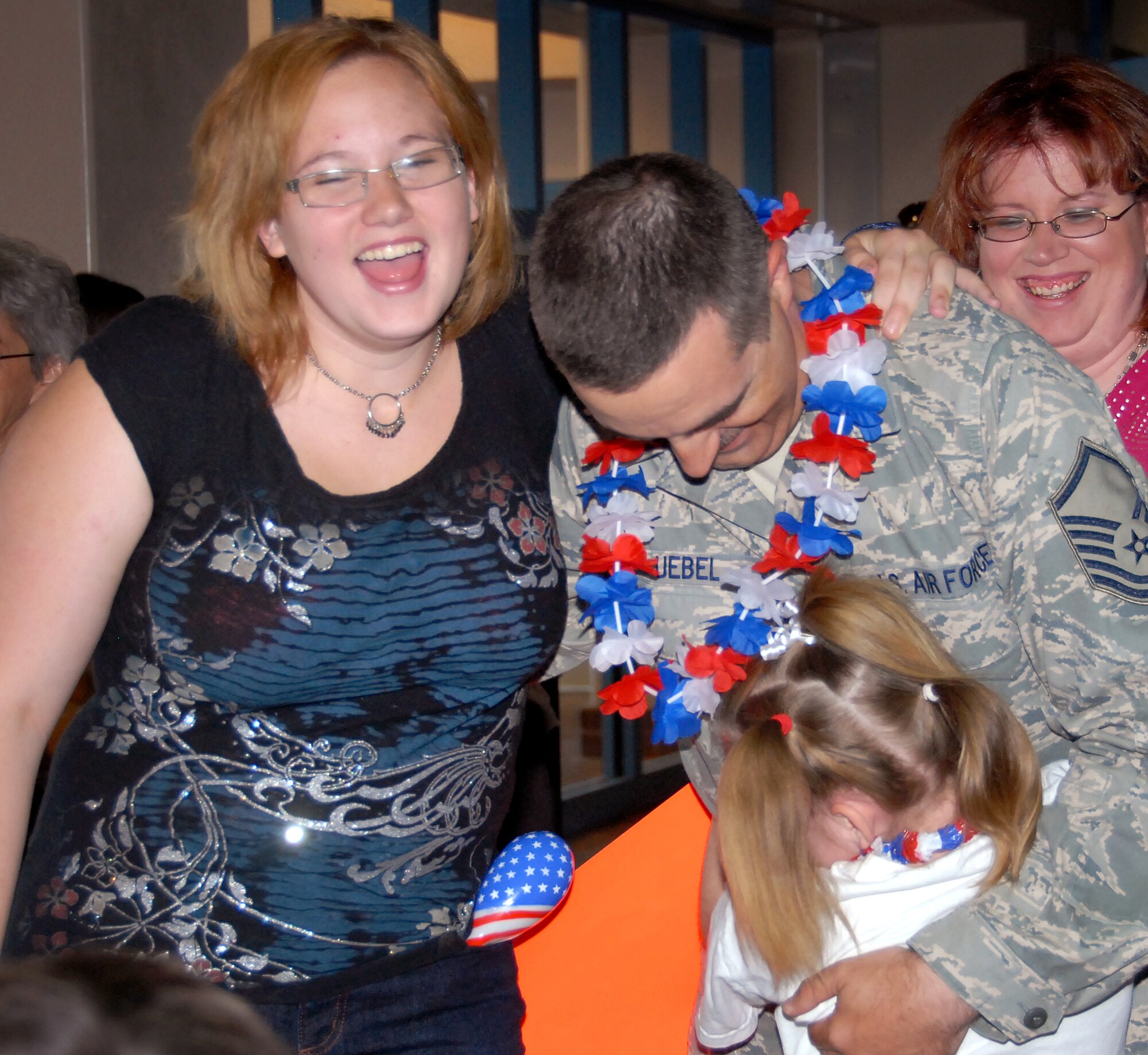 Master Sgt. Anthony Uebel, 58th Maintenance Operations Squadron, had a joyous reunion with his family, Mary Uebel, left, Theresa Uebel, middle, and his wife Nicole Uebel.  Master Sgt. Uebel returned from Iraq after a year-long tour on June 3. U.S. Air Force Photo by Elizabeth Martinez

