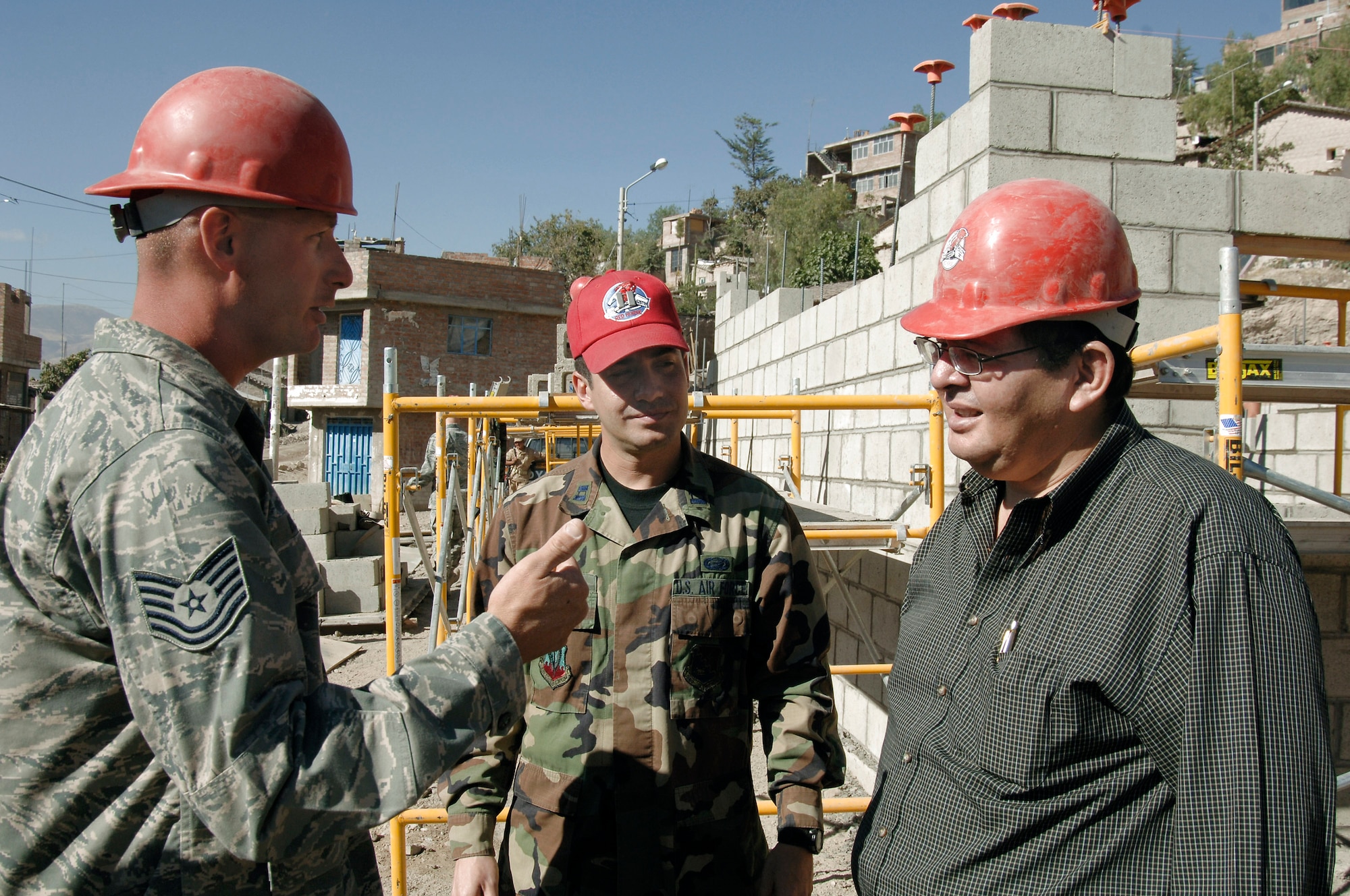 Tech. Sgt. Chris Belknap describes the construction progress of a clinic the 820th RED HORSE Squadron engineers are building July 13 in San Cristobal, Peru, to Dr. Luis Cabena, the chief of staff to the Peruvian Ministry of Defense. The engineers are part of a task force supporting New Horizons-Peru 2008, a U.S. and Peruvian effort to bring quality-of-life improvements to the people of Peru. Sergeant Belknap is the project manager. (U.S. Air Force Photo/1st Lt. Mary Pekas) 