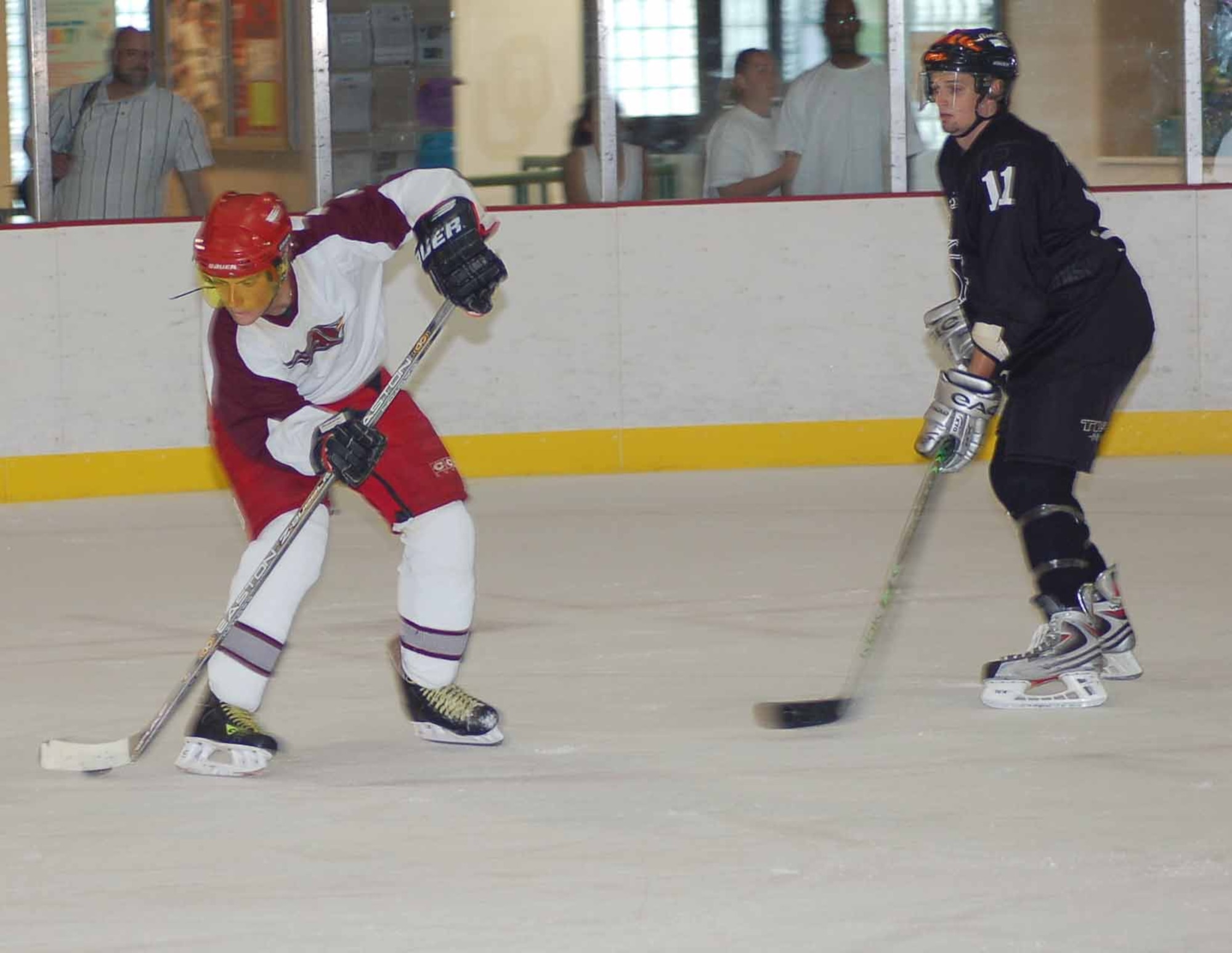 Tinker Hawks I center Jon Jansenvangalen tries to slide the puck between his skates in an Oklahoma City Adult Hockey League Division II matchup against the Knights July 13 at the Blazers Ice Centre.  The Hawks won 5-3.  (Air Force photo by Johm E. Banks)