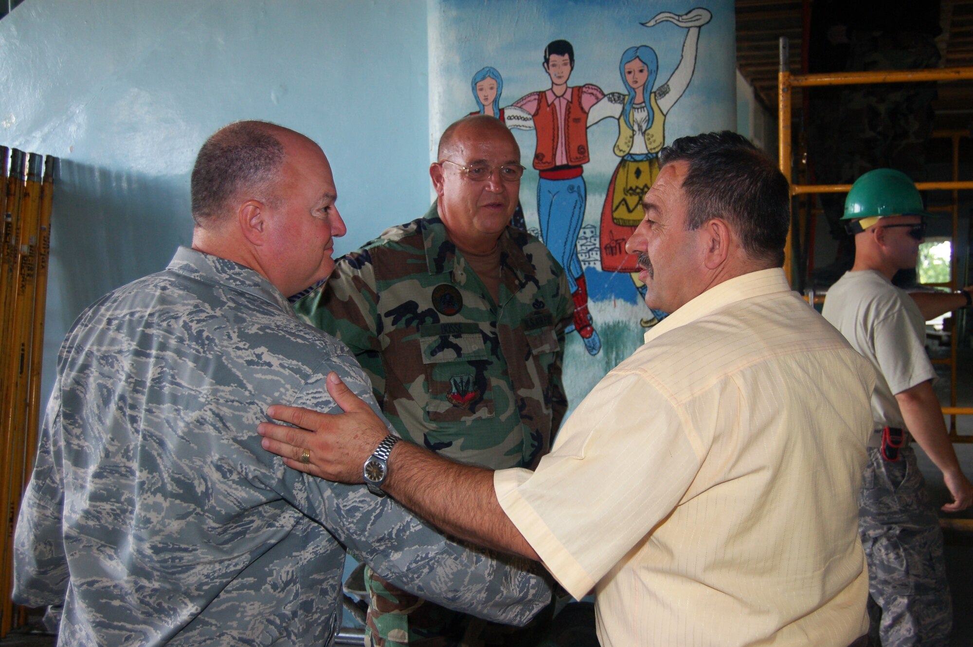 Lt. Col John P. McVicker, 175th Civil Engineer Squadron commander, Chief Master Sgt. Mike Bosse, civil engineering manager, both of the Maryland Air National Guard, greet  Dragomir Stupar, mayor of Vlasenica, Republika Srpska, Bosnia-Herzegonvina. The Guardsmen are rebuilding a school in Vlasenica as part of a humanitarian civic action project under the auspices of the National Guard’s State Partnership Program. (U.S. Air Force photo by Tech. Sgt. David D. Speicher)
