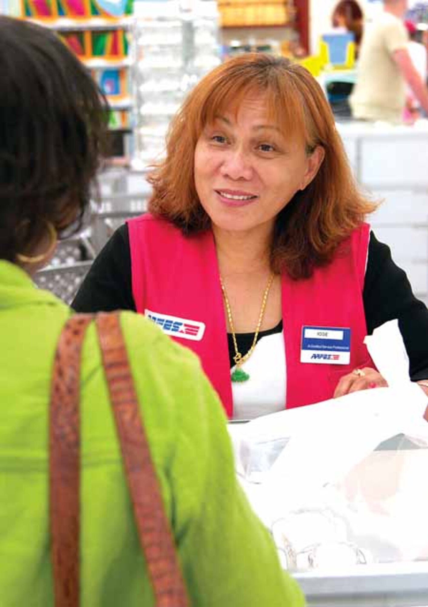 While Josie Alger loves helping people at the Tinker Base Exchange, her heart is with the men and women serving in Iraq.  The Army and Air Force Exchange Service employee has deployed to the war zone three times in the last five years.  (Air Force photo by Margo Wright)