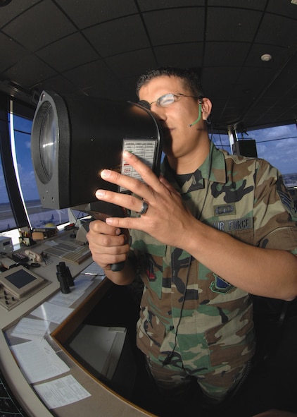 DYESS AIR FORCE BASE, Texas -- Senior Airman Gabriel Ramirez, 7th Operations Support Squadron, flashes the signal lights from the Dyess Air Traffic Control Tower July 9. Signal lights let the aircraft and vehicles know the direct urgency. (U.S. Air Force Photo by Airman 1st Class Stephen Reyes)