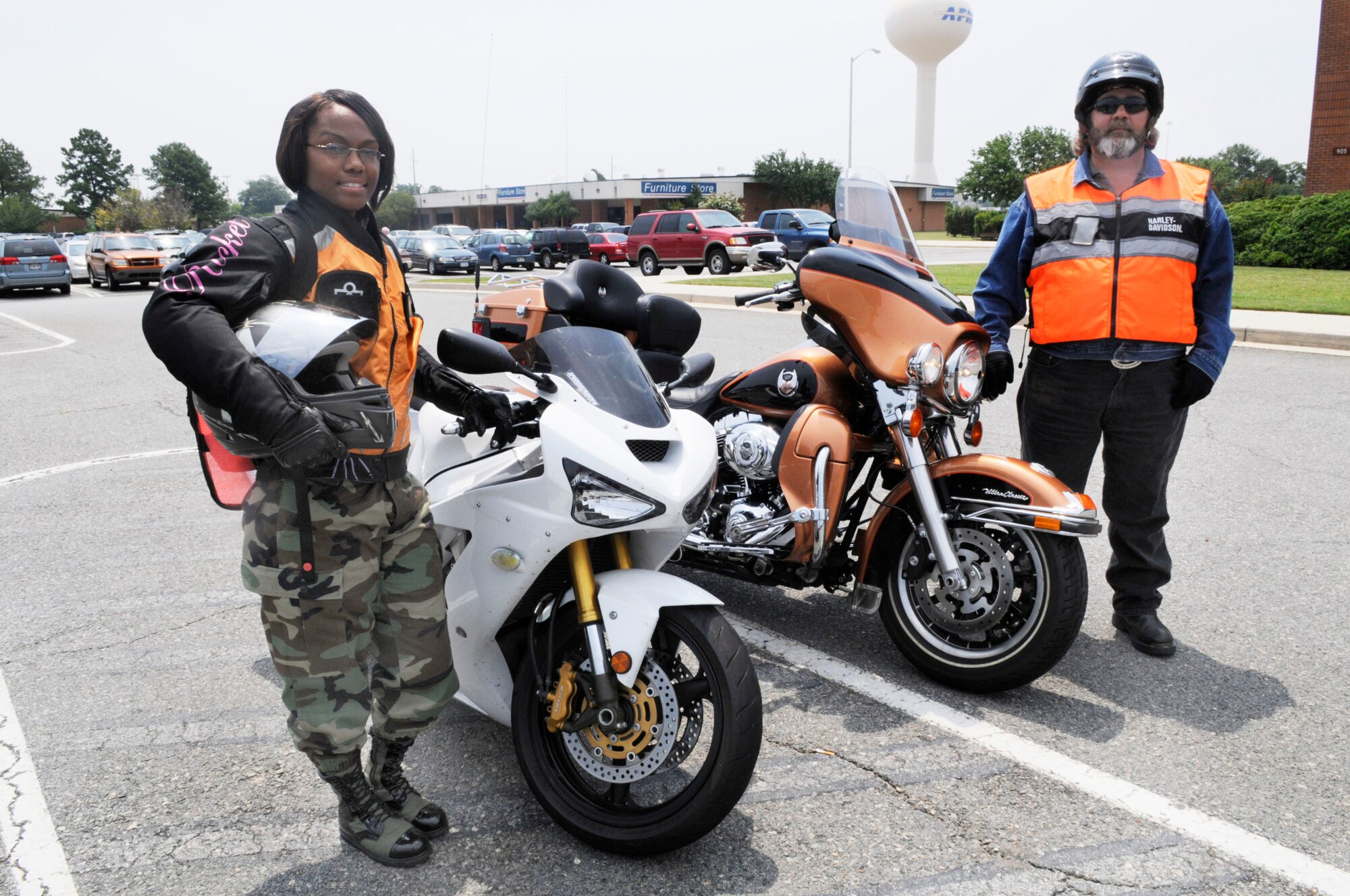 SSgt. Adria "Dee" Edwards, with her Kawasaki Ninja 636, and William Haffner, with his Harley Davidson Ultra Classic Electra Glide, show the proper equipment for motorcycle riding. That equipment includes helmet, gloves, over the ankle hard toe boots, long sleeves and pants, and a reflective vest. If the rider is carrying a backpack it should be reflective as well. U. S. Air Force photo by Sue Sapp
