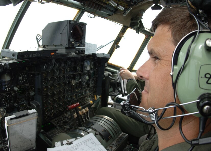 DYESS AIR FORCE BASE, Texas -- Lieutenant Col. Bret Crenwelge, C-130 pilot with the 317th Airlfit Group, peers out of the side window of a Dyess C-130 Hercules, while flying in a 10-plane formation July 16. (U.S. Air Force Photo by Airman 1st Class Micheal Breaux)