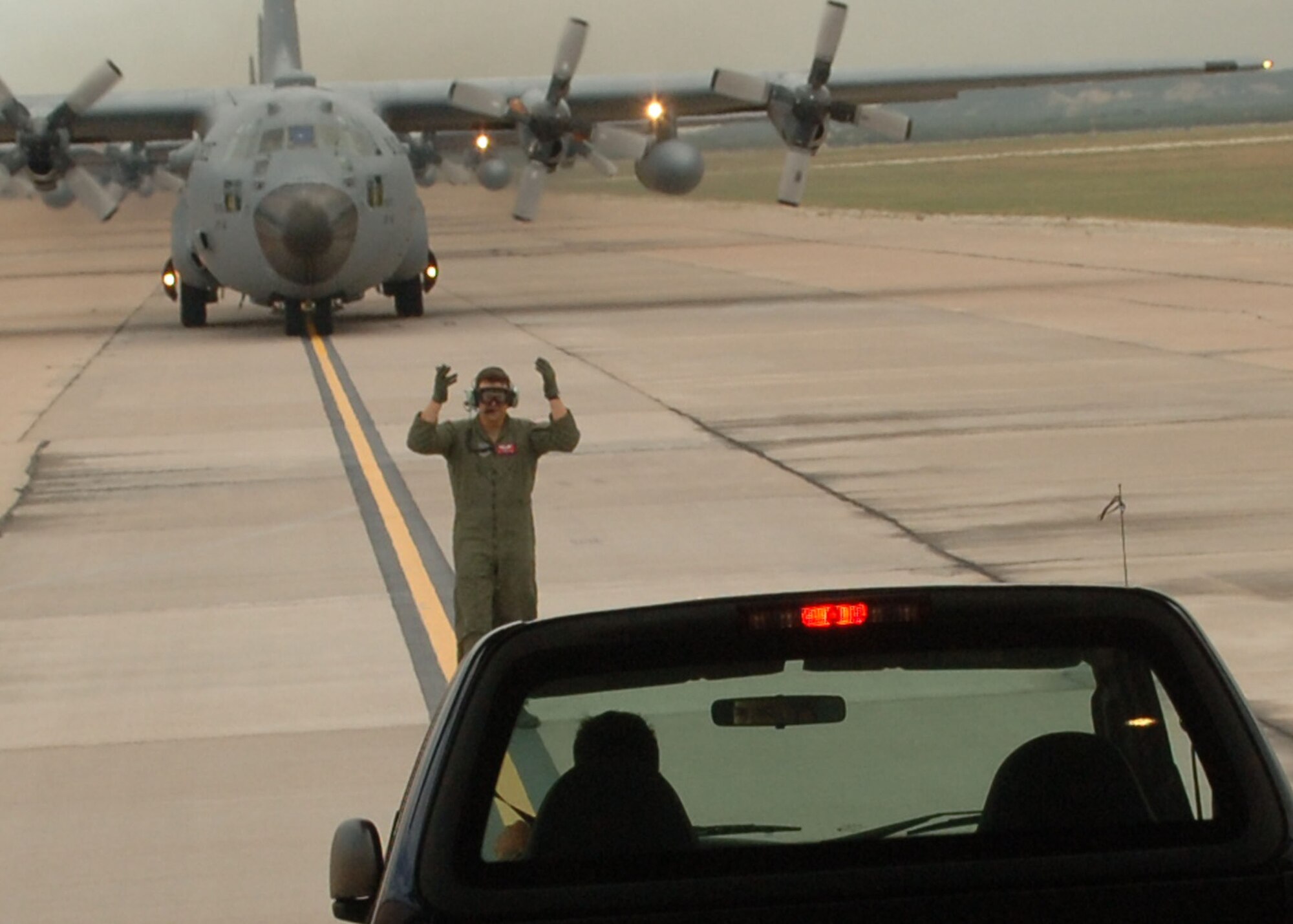 DYESS AIR FORCE BASE, Texas -- A Dyess loadmaster marshalls a truck off of a C-130 during a 10-plane formation flight July 16. (U.S. Air Force Photo by Airman 1st Class Micheal Breaux)