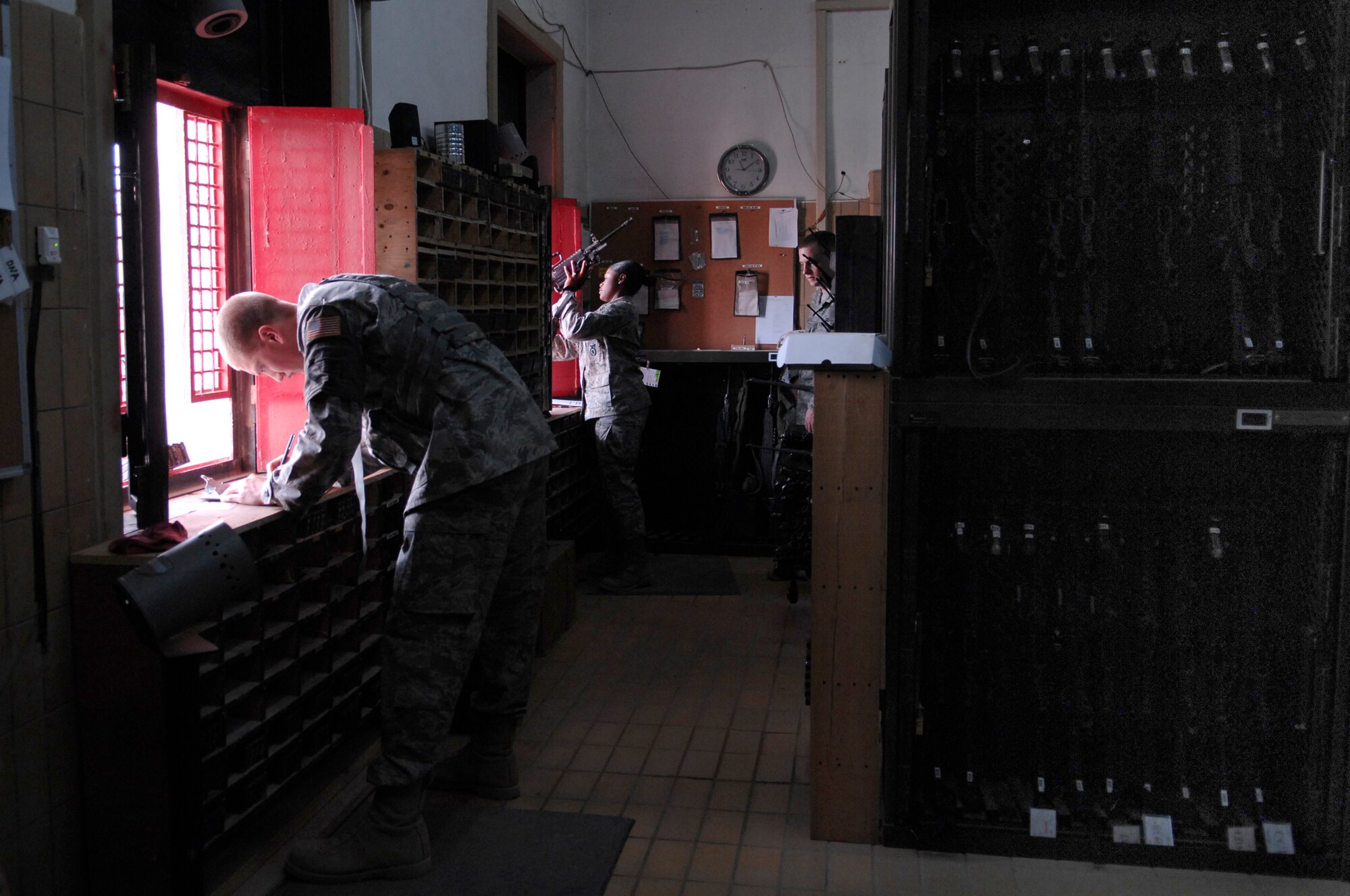 JOINT BASE BALAD, Iraq -- Senior Airman Matthew Sampers and Airman 1st Class Alexandria Brye, 332nd Expeditionary Security Forces Squadron armorers, issue various weapons and ammunition to security forces Airman for base defense. Airman Sampers is deployed from Andrews Air Force Base, Md., and Airman Brye is deployed from Royal Air Force Alconbury, England. (U.S. Air Force photo/Senior Airman Julianne Showalter)