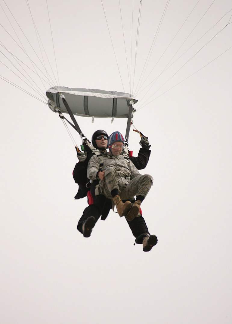 7/9/2008 - Master Sgt. Timothy Kane, 37th Security Forces Squadron, arrives at his retirement ceremony July 9 with some help from Staff Sgt. Nicholas Seibel, 342nd Training Squadron. For his retirement, Sergeant Kane did a tandem jump with Sergeant Seibel, landing at the basic military training parade grounds. (USAF photo by Robbin Cresswell) 