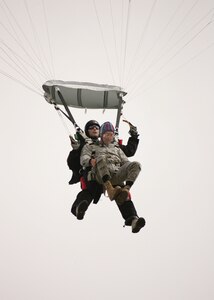 7/9/2008 - Master Sgt. Timothy Kane, 37th Security Forces Squadron, arrives at his retirement ceremony July 9 with some help from Staff Sgt. Nicholas Seibel, 342nd Training Squadron. For his retirement, Sergeant Kane did a tandem jump with Sergeant Seibel, landing at the basic military training parade grounds. (USAF photo by Robbin Cresswell) 