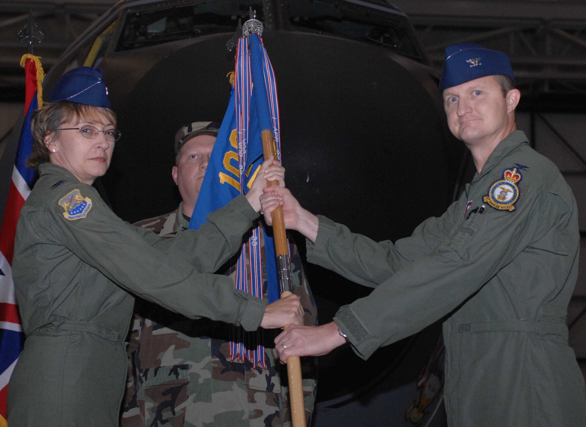 RAF MILDENHALL, England -- Col. Eden Murrie, 100th Air Refueling Wing commander, bestows command of the 100th Operations Group to Col. Creg Paulk during a change of command ceremony July 17. Col. Paulk, recently arrived from Cheyenne Mountain Air Force Station, Colo., assumes command from Col. J.D. Clifton. (U.S. Air Force photo by Airman 1st Class Brad Smith)