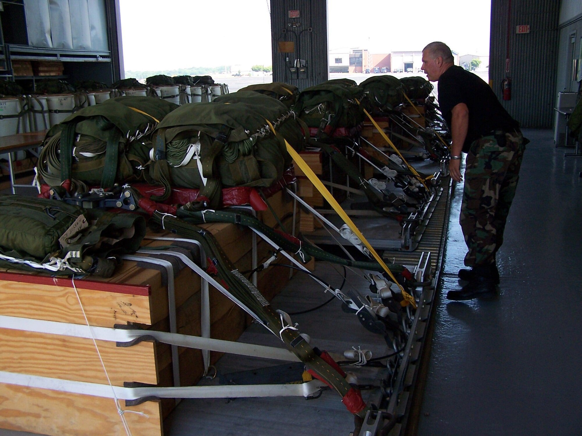 Master Sgt. Ken Grabowski, 166th Aerial Port Flight, Delaware Air National Guard, checks pallet documentaton sheets for heavy equipment loads used for air drop training missions by 166th Airlift Wing C-130 transport aircraft.