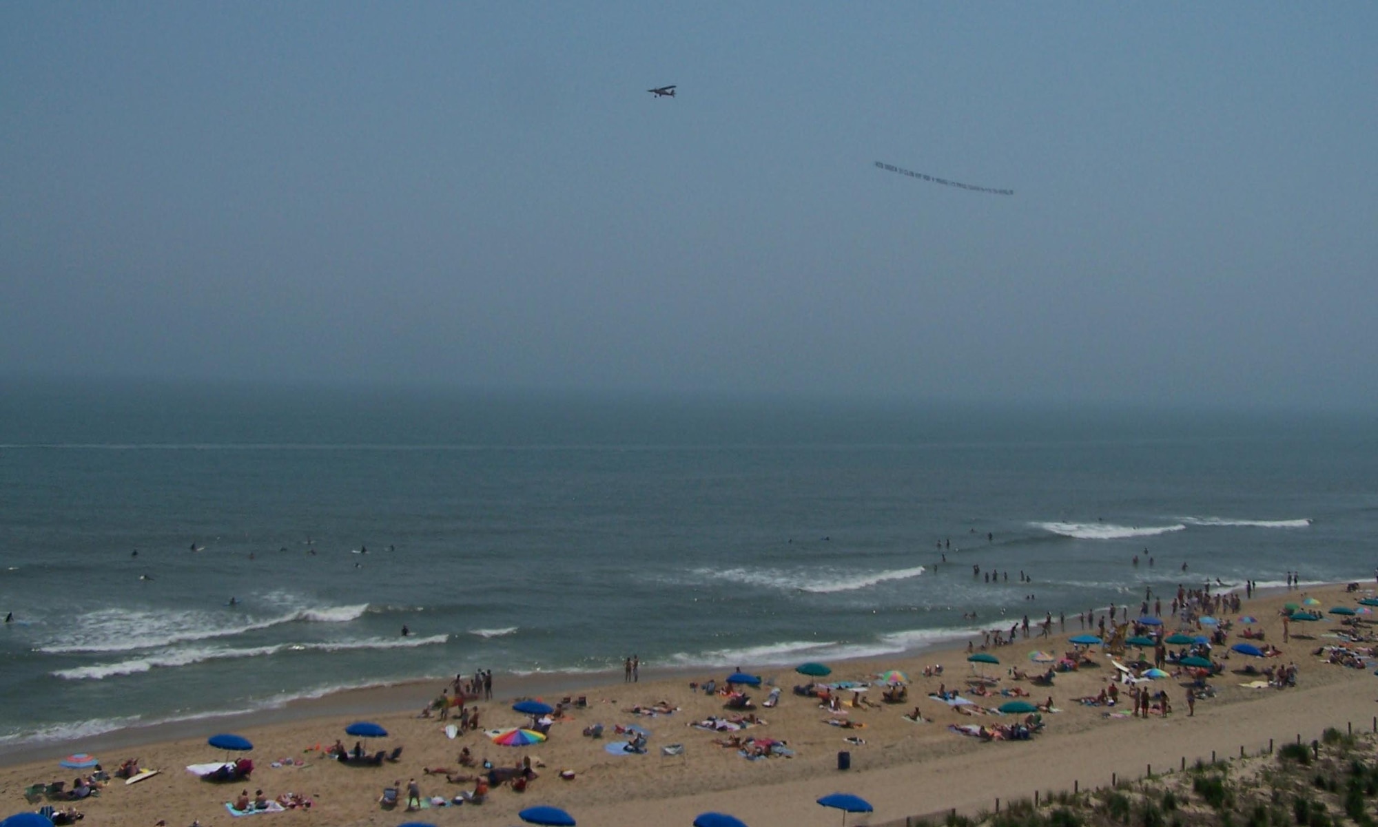 A banner-towing small civilian aircraft owns the sky over Ocean City, Md. shortly before a five-ship large formation of Delaware Air National Guard C-130 transport aircraft from the 166th Airlift Wing in New Castle, Del. flew overhead.  Beachgoers at Md. and Del. coastal areas saw part of the 700-mile, three-hour training flight on June 7, 2008 over four states (Del., Md., Va., and N.J.) culminating in an airdrop over Coyle Field, N.J. and a return to home station at New Castle Airport, Del.