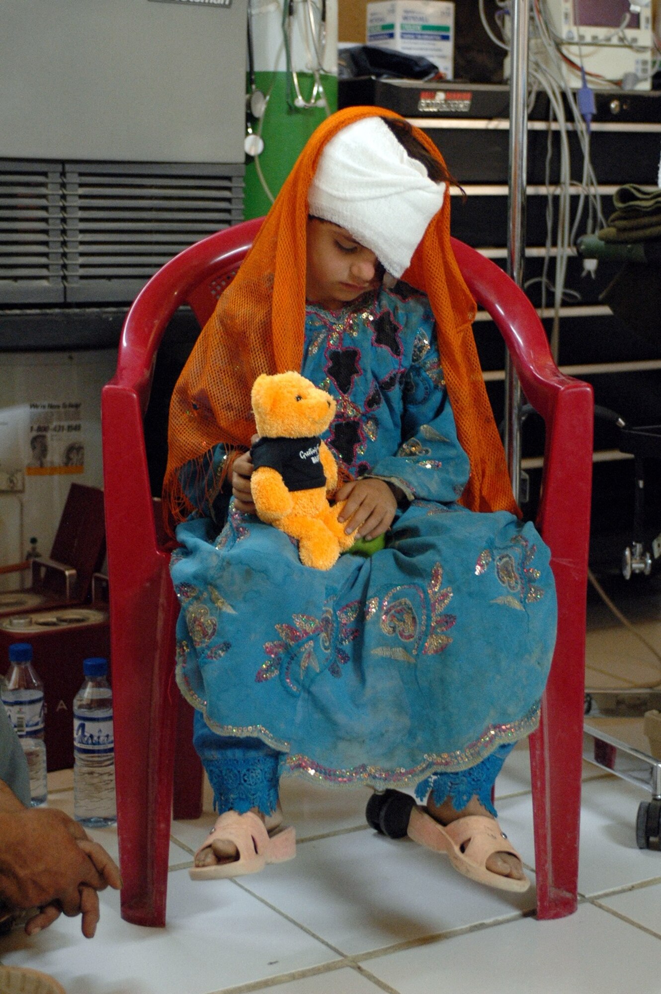 BAGRAM AIR FIELD, Afghanistan -- Gulzana Haqim, a 6-year-old Afghan girl, waits in a Special Forces medical facility before being transported to Craig Joint Theater Hospital on Bagram Air Field for examination, June 9. The young girl was diagnosed with a tumor over her eye - an affliction that has an extremely low chance of survival in Afghanistan. However, Coalition doctors treated her and she is on her way to recovery. (Photo by Sgt. Daniel Love)