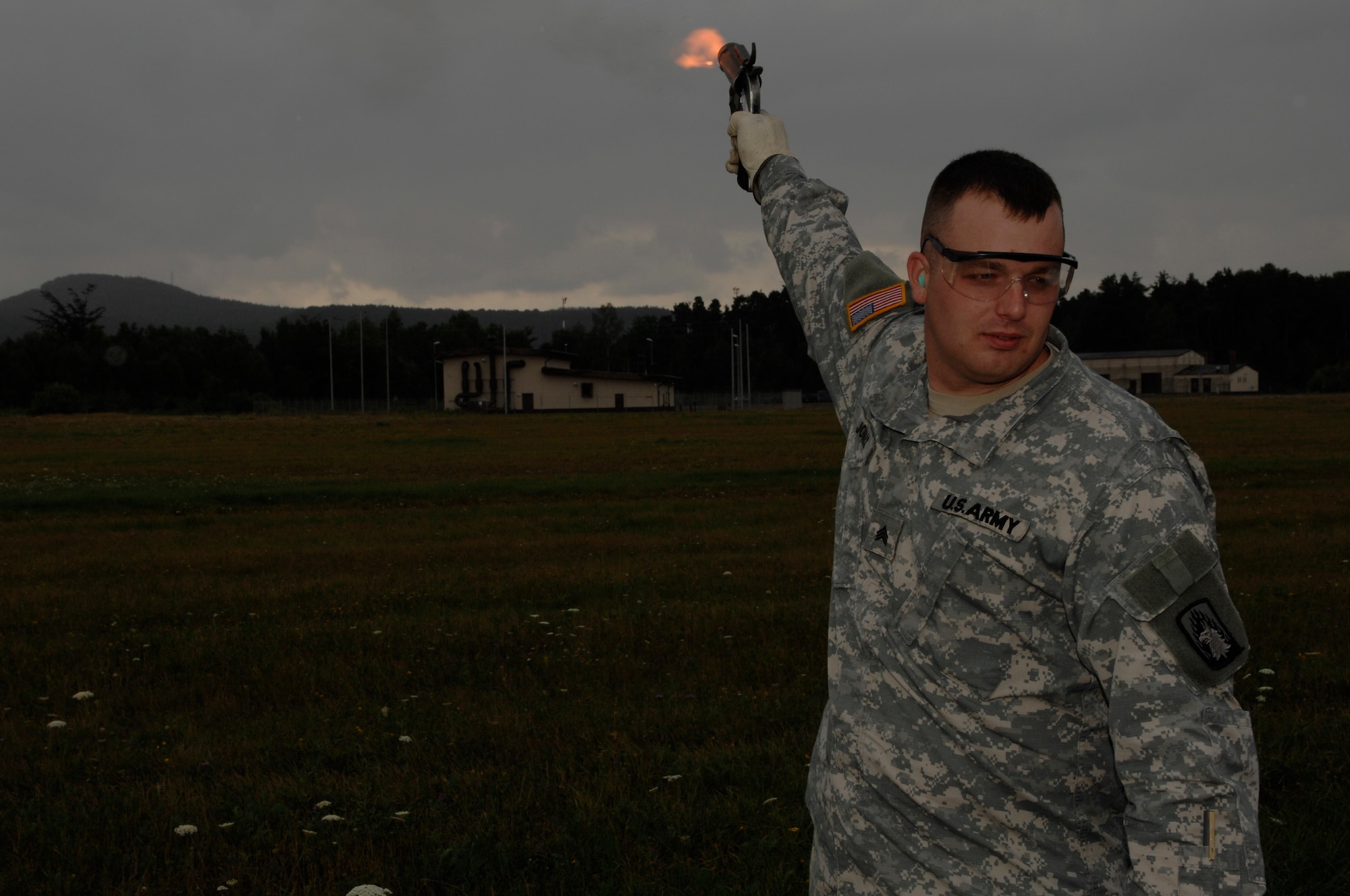 U.S. Army Sgt. Jason Johns, 3d Battalion, 58th Aviation Regiment, Illsheim, Germany, fires a very pistol to scare off birds, July 17, 2008, Ramstein Air Base, Germany.  Airfield managers from the 86th Operations Support Squadron are training Army Soldiers in a first-ever Department of Defense pilot program. (U.S. Air Force photo by Senior Airman Amber Bressler)(Released)