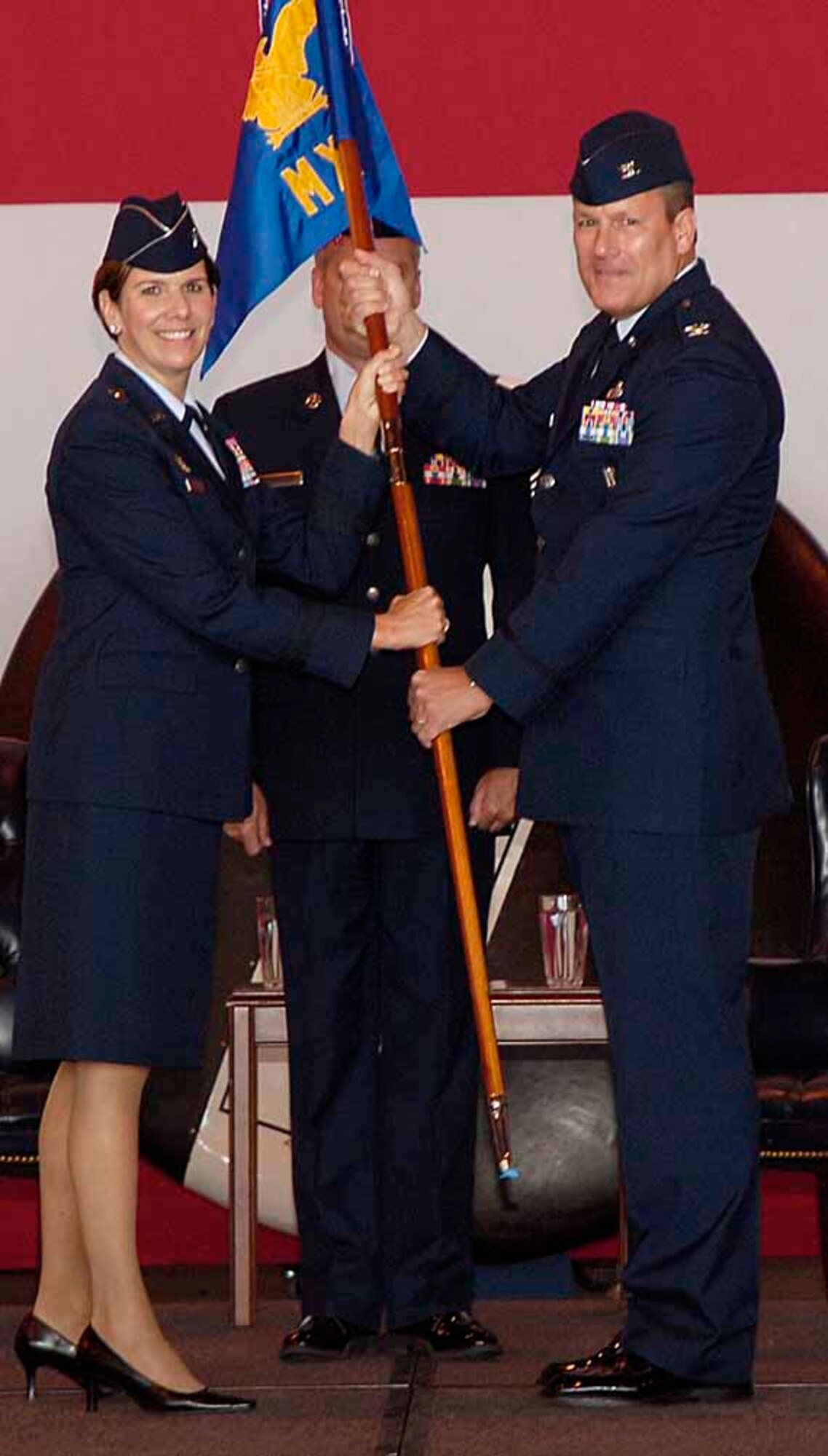 Brig. Gen. Lori Robinson, 552nd Air Control Wing commander, passes command of the 552nd Maintenance Group to Col. Lawrence Hinkin in an Assumption of Command ceremony July 1.  The colonel will manage and coordinate all activities for more than 1,500 personnel in support of 32 E-3 aircraft valued at $9.6 billion.(Air Force photo by Kelly White)
