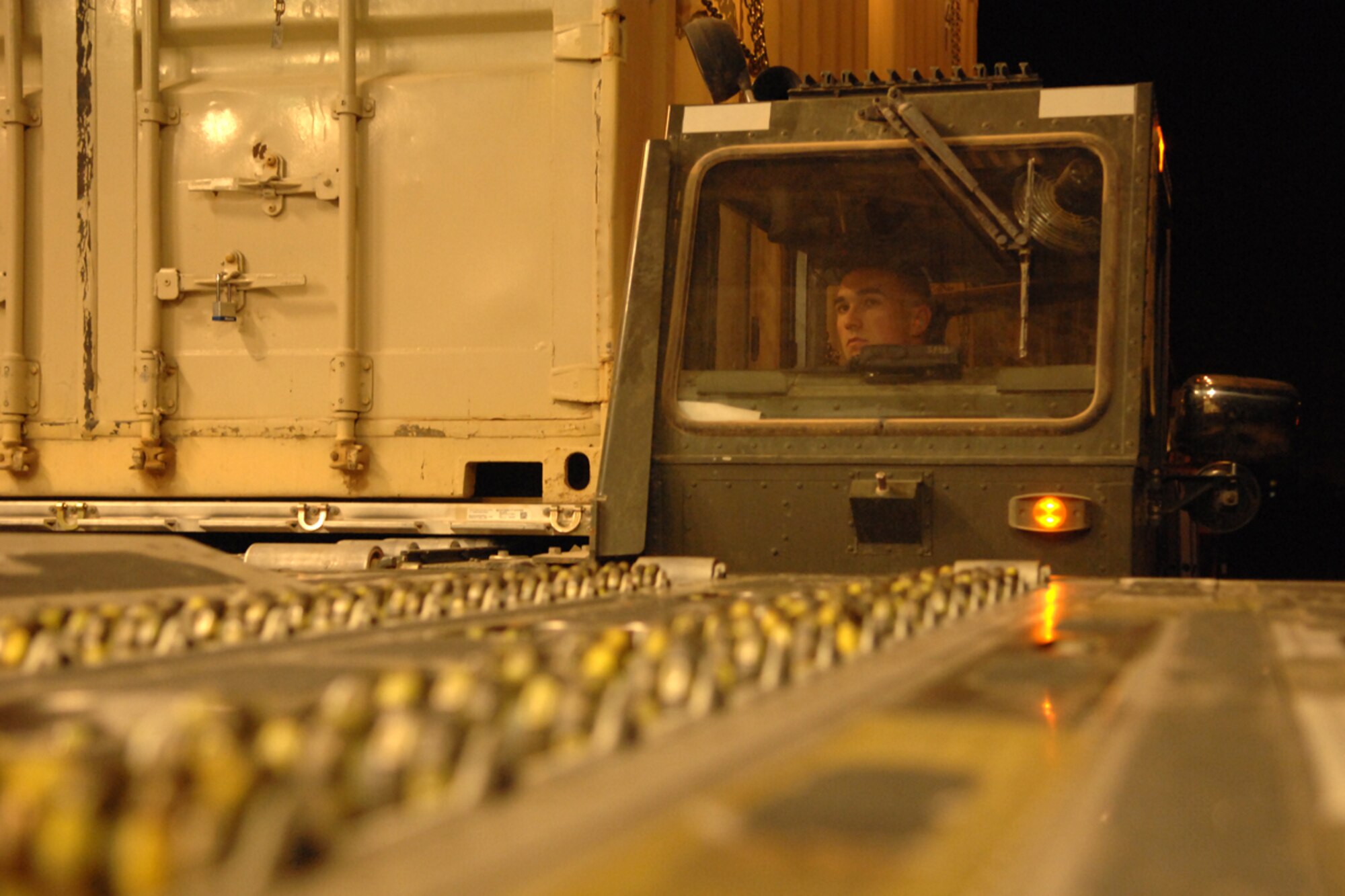 KIRKUK REGIONAL AIR BASE, IRAQ -- Staff Sergeant Shain Brower, 506th Expeditionary Logistics Readiness Squadron Air Freight Loader, uses a 60k aircraft loader to upload a T-3 trailer onto a C-17 July 18.  The 13,000-pound trailer was part of the 47,000 pounds loaded on the C-17.  The 506 ELRS loads and unloads nearly 490,000 pounds of cargo a week onto military aircrafts. Sergeant Brower is deployed from Charleston Air Force Base, S.C. and calls Middleville, Michigan home. (U.S. Air Force photo/Senior Airman Randi Flaugh)
