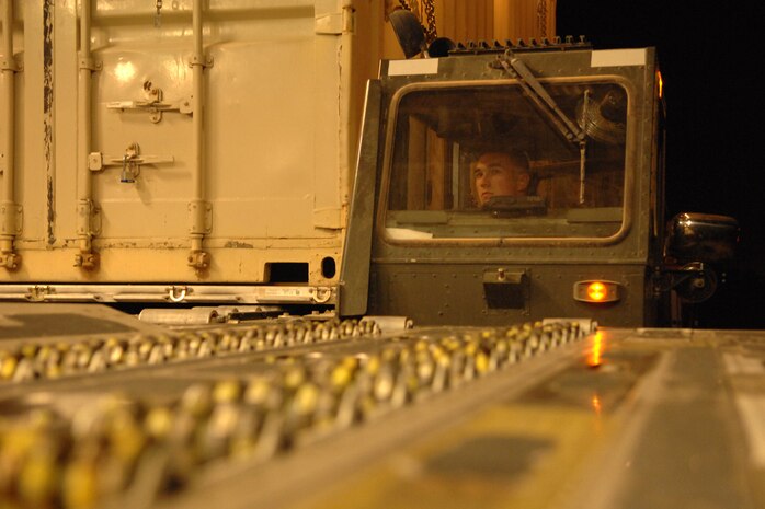 KIRKUK REGIONAL AIR BASE, IRAQ -- Staff Sergeant Shain Brower, 506th Expeditionary Logistics Readiness Squadron Air Freight Loader, uses a 60k aircraft loader to upload a T-3 trailer onto a C-17 July 18.  The 13,000-pound trailer was part of the 47,000 pounds loaded on the C-17.  The 506 ELRS loads and unloads nearly 490,000 pounds of cargo a week onto military aircrafts. Sergeant Brower is deployed from Charleston Air Force Base, S.C. and calls Middleville, Michigan home. (U.S. Air Force photo/Senior Airman Randi Flaugh)
