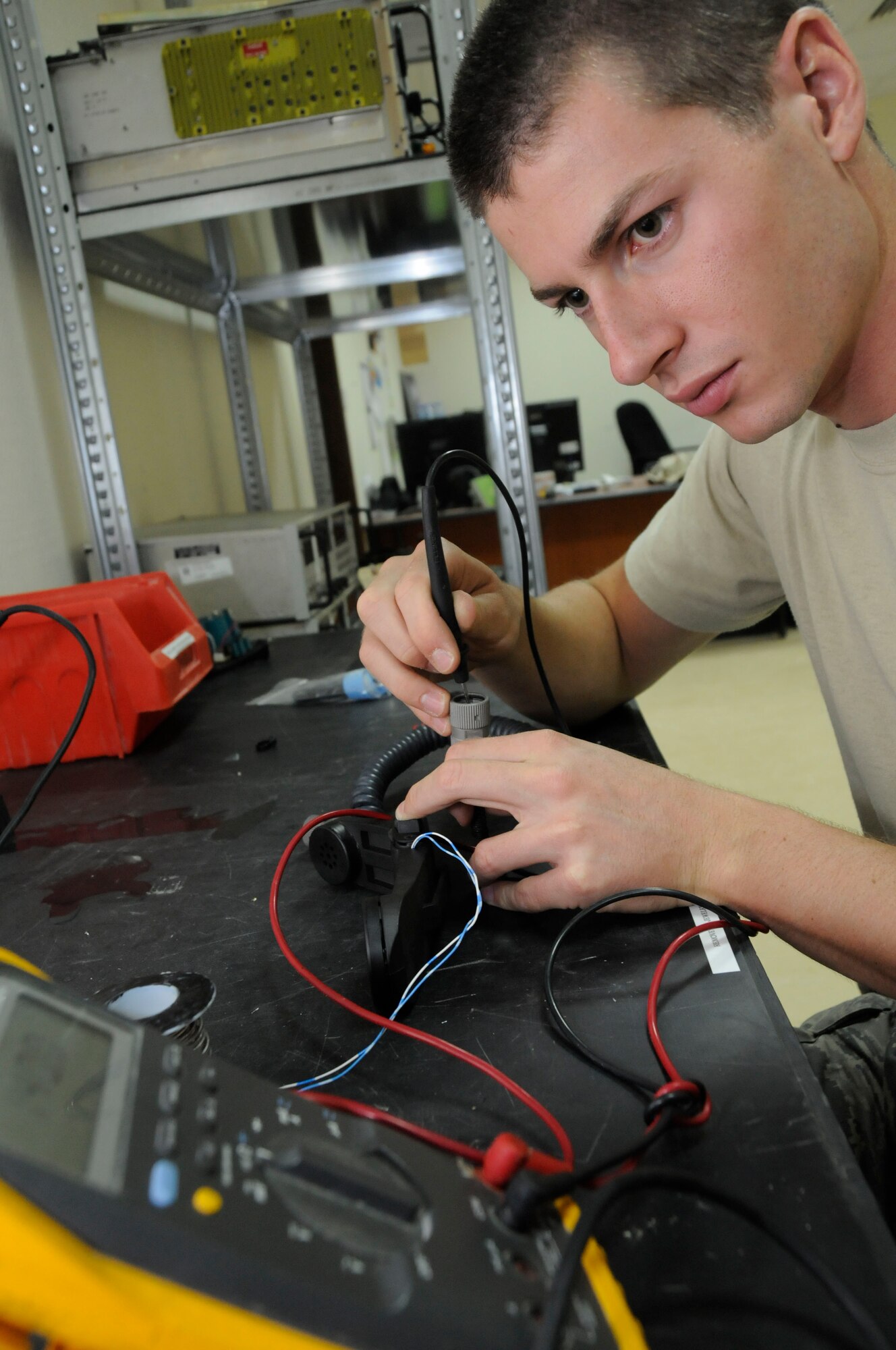 Senior Airman Sven Bickham, 379th Expeditionary Communications Squadron, checks the continuity between components in a handset July 14 in Southwest Asia. Airman Bickham is a radio maintainer deployed from Hickam Air Base, Hawaii. (U.S. Air Force photo by Staff Sgt. Darnell T. Cannady)