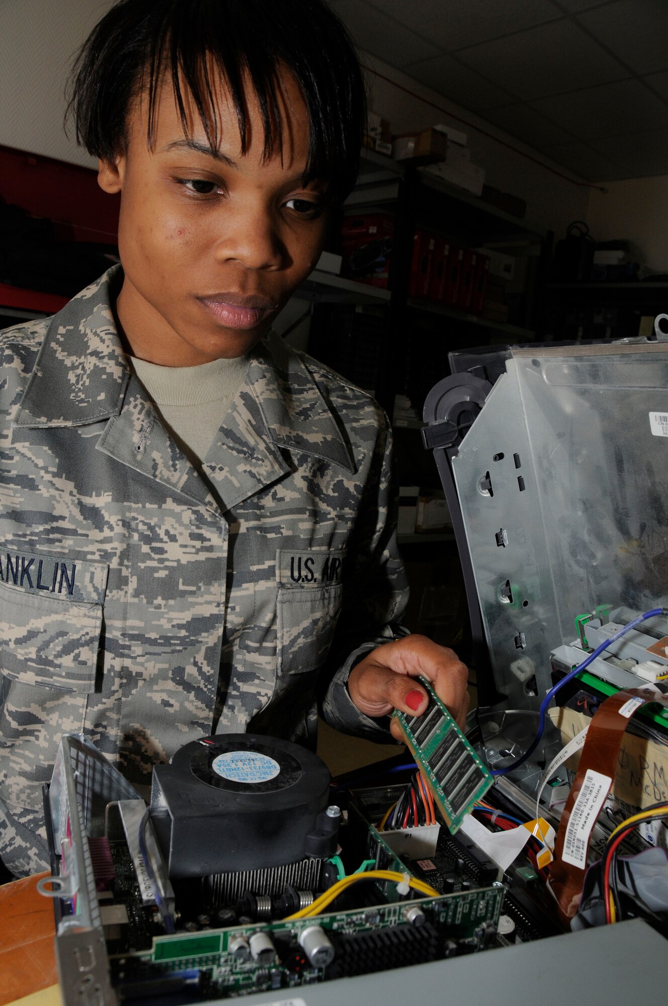 Airman 1st Class Wanessa Franklin, 379th Expeditionary Communications Squadron, installs random access memory into a computer here July 14. Airman Franklin is a small computer technician deployed from Beale Air Force Base, California. (U.S. Air Force photo by Staff Sgt. Darnell T. Cannady)