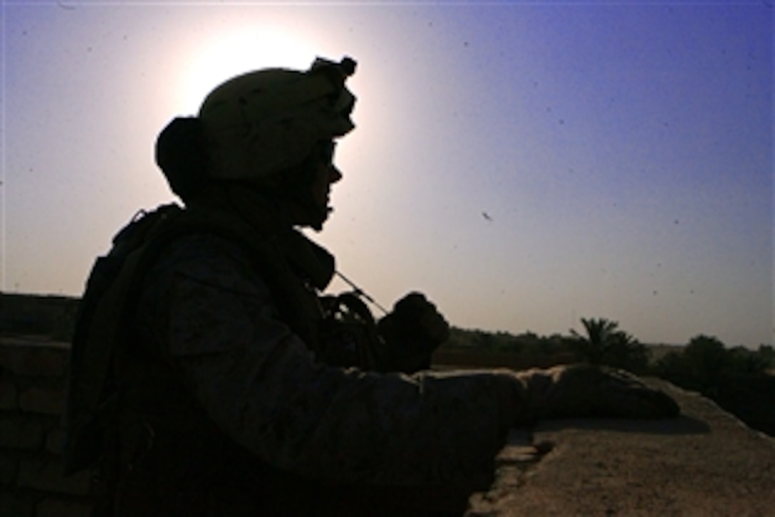 U.S. Marine Lance Cpl. Josh A. Buege provides overhead security during a combined medical engagement training exercise in Mudiq, Iraq, July 6, 2008. Buege is assigned to Company F, 2nd Battalion, 24th Marine Regiment. 