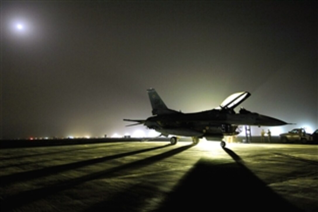 A U.S. Air Force F-16 Fighting Falcon aircraft sits on a trim pad before an engine run up at Joint Base Balad, Iraq, July 16, 2008. 