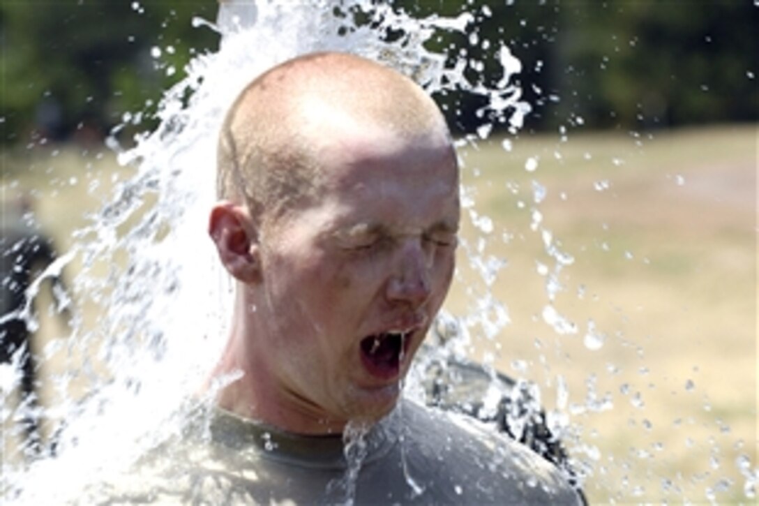 U.S. Air Force Academy basic cadet Taylor rinses off after running the assault course during the field training portion of basic training at the academy in Colorado, July 16, 2008. 