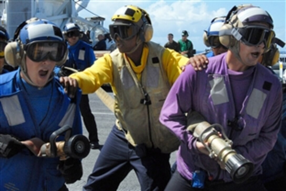 U.S. sailors fight a simulated fire during a flight deck fire drill aboard the amphibious assault ship USS Bonhomme Richard in the Pacific Ocean, July 17, 2008. Bonhomme Richard is at sea for Rim of the Pacific exercise 2008.