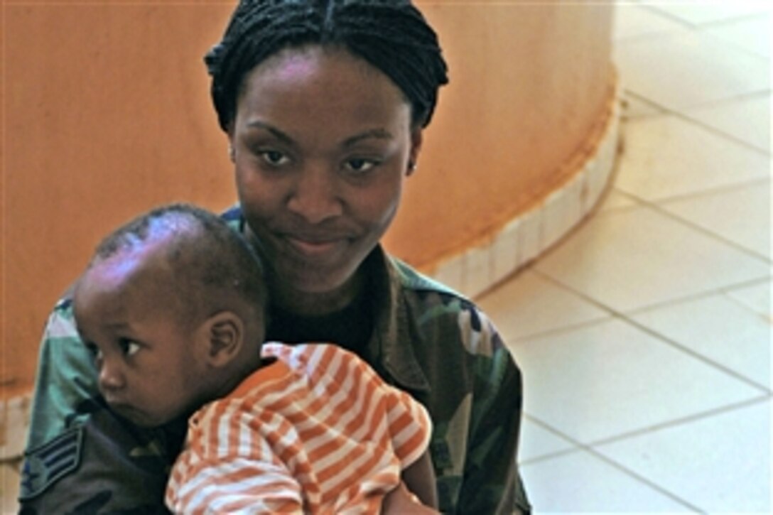U.S. Air Force Senior Airman Latrisha Peebles holds a Malian baby, July 16, 2008, at a local orphanage in Bamako, Mali. Peebles is one of more than 90 servicemembers deployed to Bamako for MEDFLAG 08, a multinational medical training exercise designed to enhance medical capabilities and readiness for U.S. and African forces. Peebles  is assigned to the 31st Medical Group.