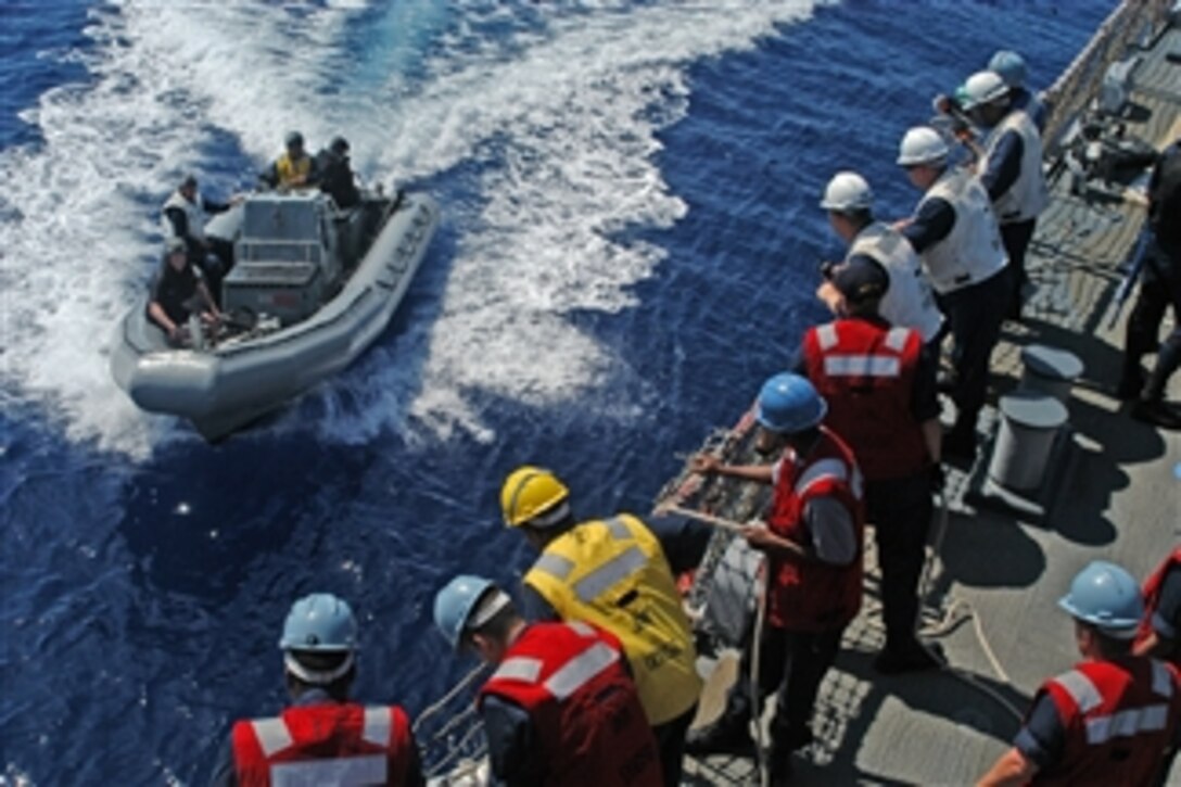U.S. Navy sailors stand by as a rigid hull inflatable boat approaches the starboard side of the guided-missile destroyer USS John S. McCain (DDG 56) during seamanship training while underway in the Pacific Ocean on July 15, 2008.  