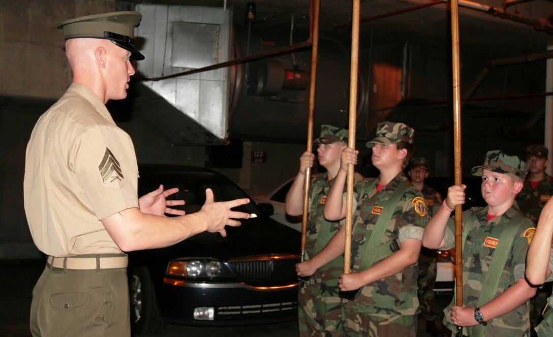 Sgt. Scott A. Jewel, 32nd Color Sergeant of the Marine Corps, instructs Young Marines in ceremonial colors drill at Marine Barracks Washington, July 18. The Manassas Young Marines toured Marine Barracks Washington and received personal instruction from members of the Marine Corps Color Guard.