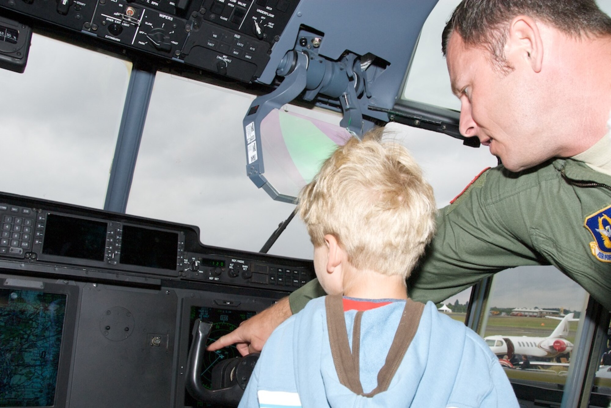 Lt. Col. David Russell explain the glass cockpit to Lucas Kaighin sitting  in the pilot seat of the Air Force Reserve C-130J from the 815th Airlift Squadron Flying Jennies.

Thousands of people from across the world have toured the C-130J at the largest air show in the world, Farnborough.

The air show presents a rare opportunity for children of all ages to see up close the most technologically advanced C-130 in the world.

"I never realized how many capabilities this plane (the J-Model) has," said one aviation enthusiast.

The Flying Jennies will continue to host guests at the air show till Sunday, July 20, 2008.