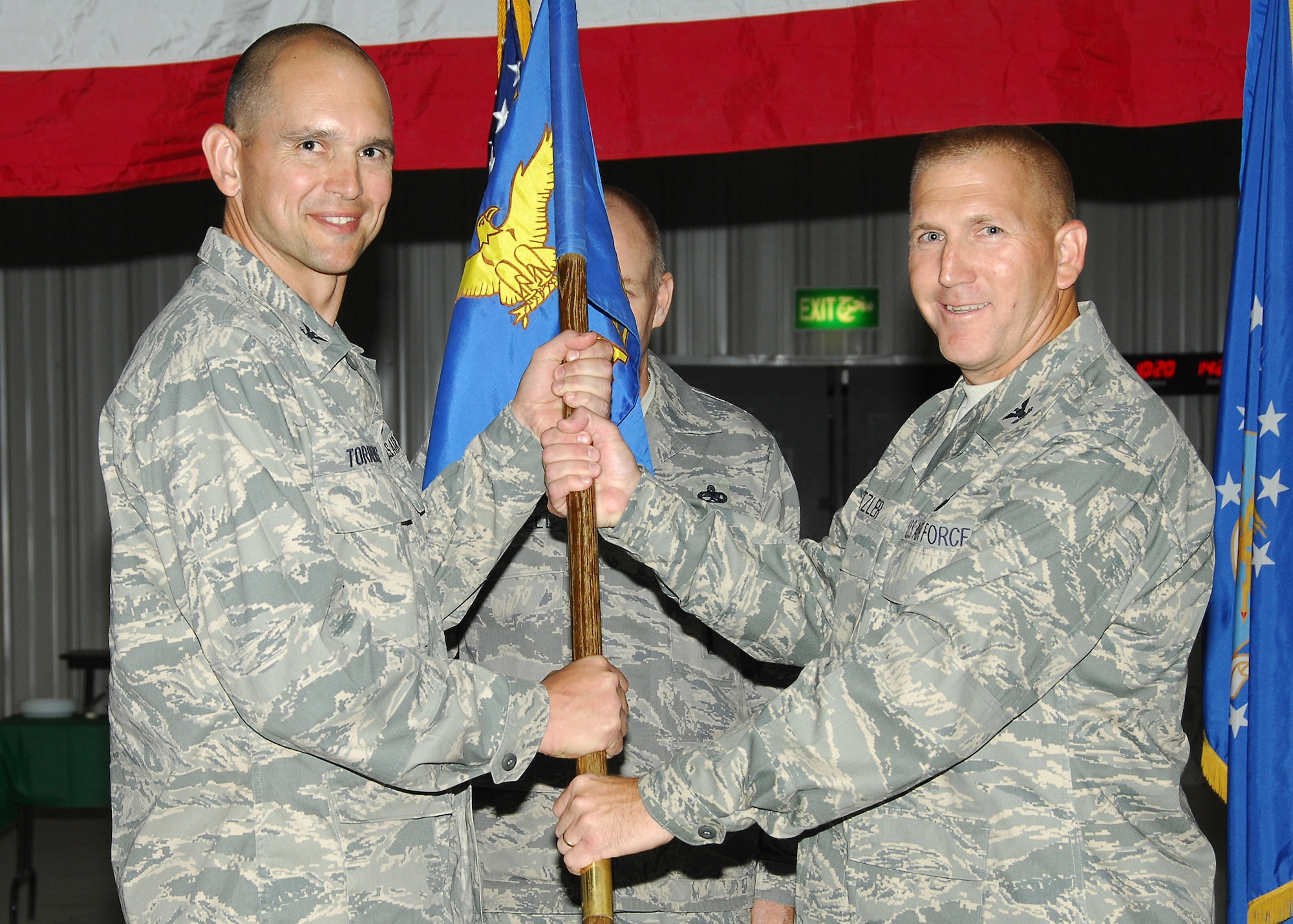 SOUTHWEST ASIA -- Col. Alan Metzler accepts the guide-on from Col. Cameron Torrens, 386th Air Expeditionary Wing commander, as he assumed command of the 586th Air Expeditionary Group from Col. Patrick Bielby during a change of command ceremony here July 18. Colonel Bielby is headed to Langely Air Force Base, Va. (U.S. Air Force photo/Tech. Sgt. Raheem Moore) 