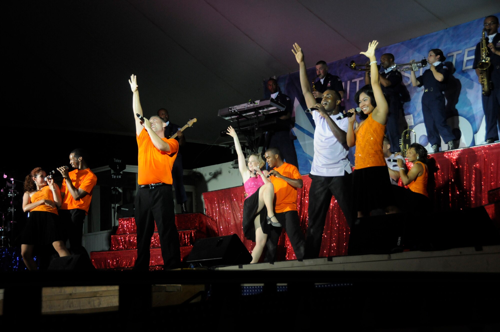 Tops in Blue performs various songs for deployed military members during their tour here July 15. Tops in Blue have been providing entertainment to military servicemembers at every base for more than 50 years. Tops in Blue preformed various songs from numerous genres including country, contemporary and rock and roll.  (U.S. Air Force photo byStaff Sgt. Darnell T. Cannady)