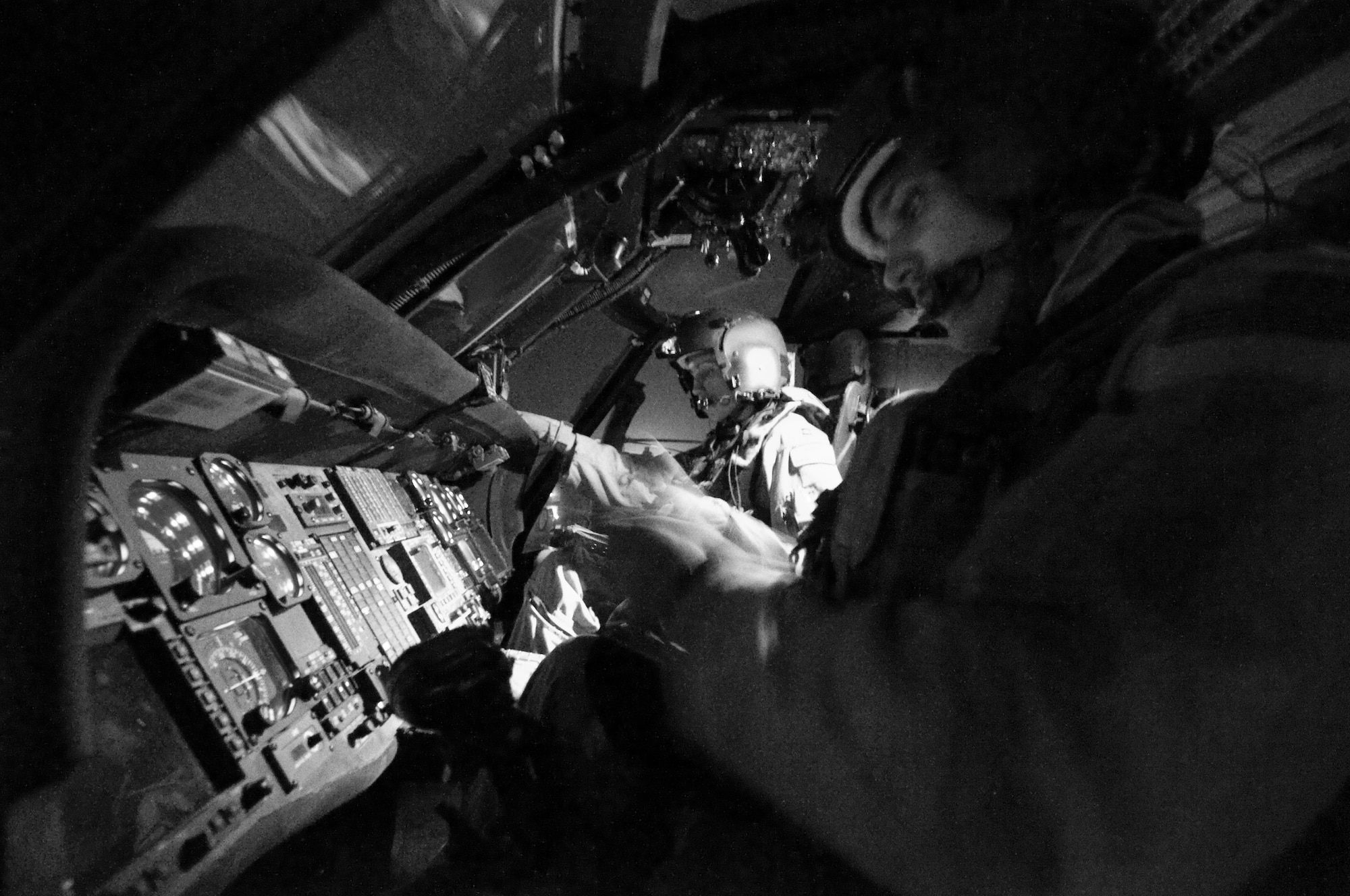 BAGRAM AIR FIELD, Afghanistan -- Capt. Jennifer Aupke (left), aircraft commander and flight lead, and 1st Lt. Thaddeus Ronnau (right), co-pilot, of the 33rd Expeditionary Rescue Squadron, double-check their gear and instrument readings here on July 17, 2008. The HH-60G Pave Hawk helicopter features an upgraded communications and navigation suite that includes integrated inertial navigation/global positioning/Doppler navigation systems, satellite communications, secure voice, and Have Quick communications. Both Captain Aupke and Lieutenant Ronnau are deployed from the 33rd Rescue Squadron, Kadena Air Base, Japan. (U.S. Air Force photo by Staff Sgt. Samuel Morse)